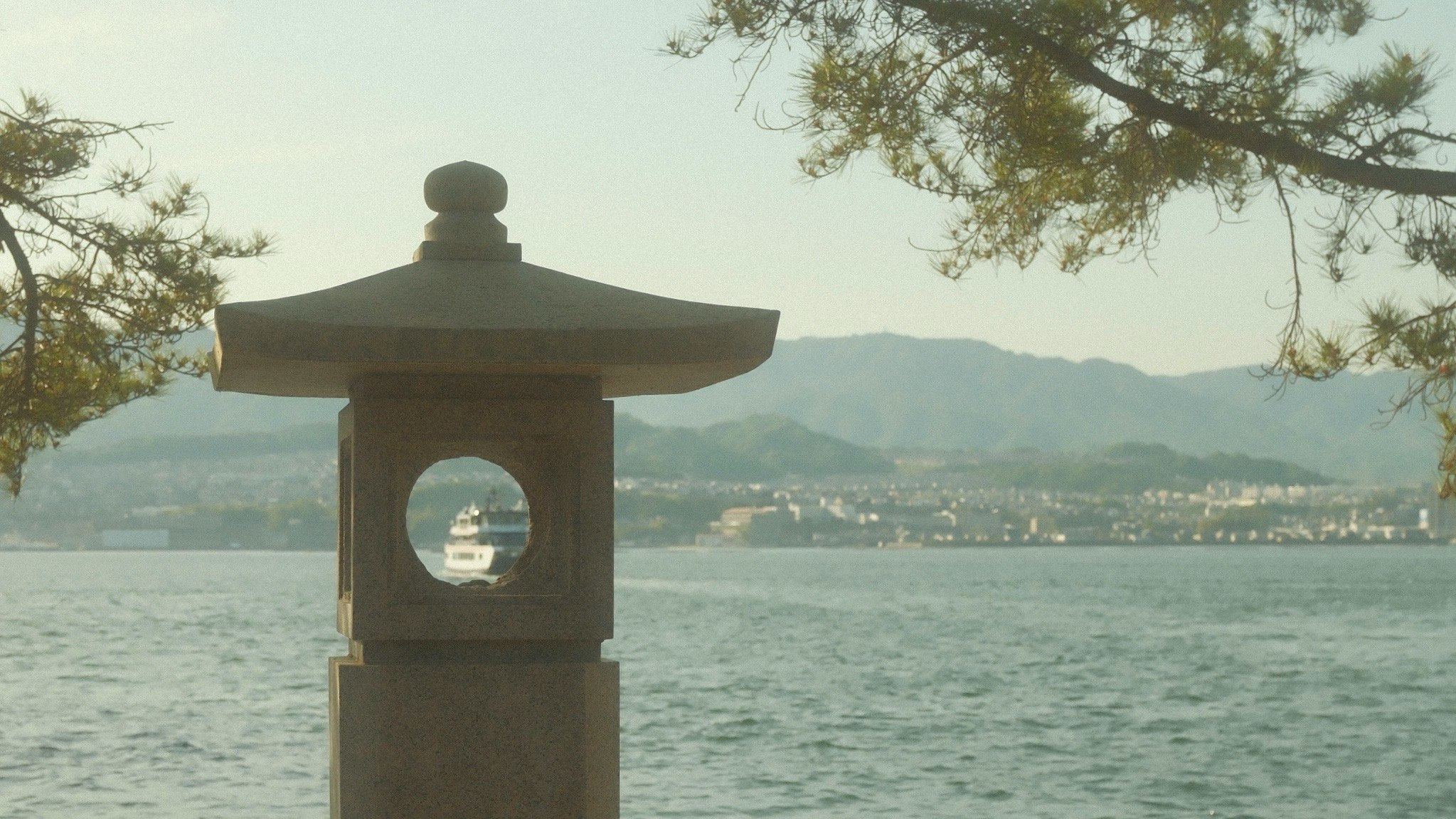 lantern by a lakeside with distant mountains