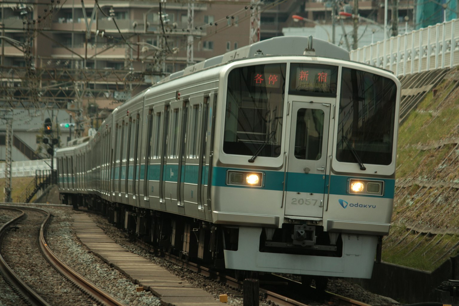Blue and white train running on curved tracks