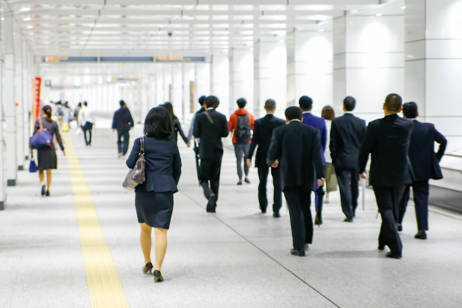 Professionnels marchant dans un couloir lumineux