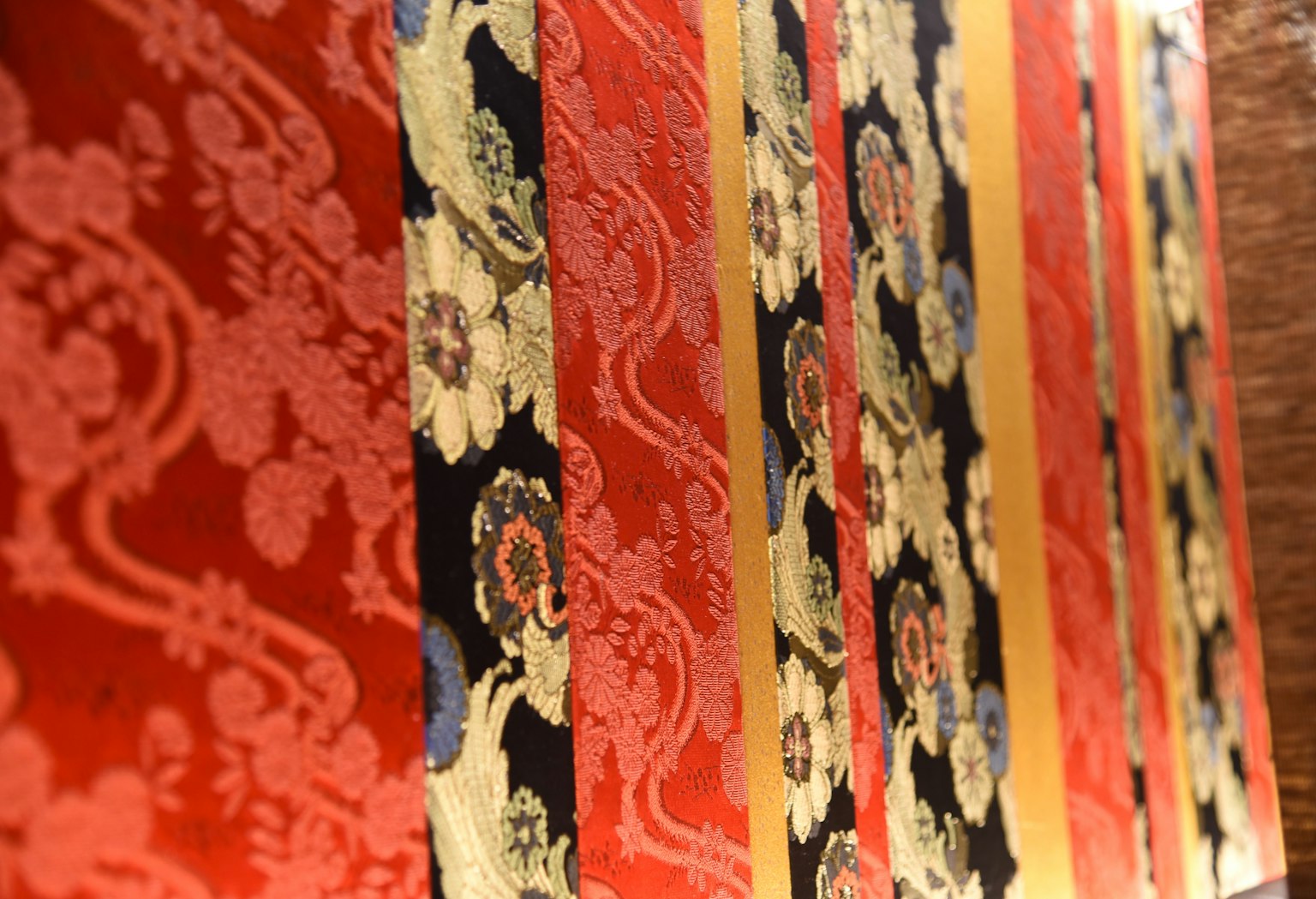 Fabric with red and black striped patterns featuring floral designs