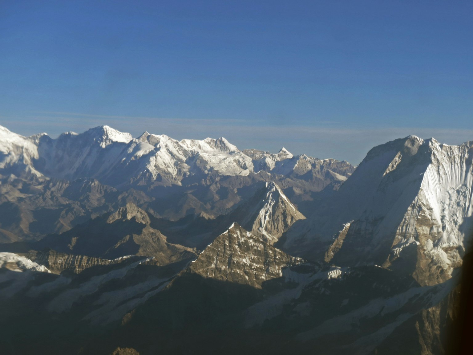 Majestic snow-covered mountains under a blue sky