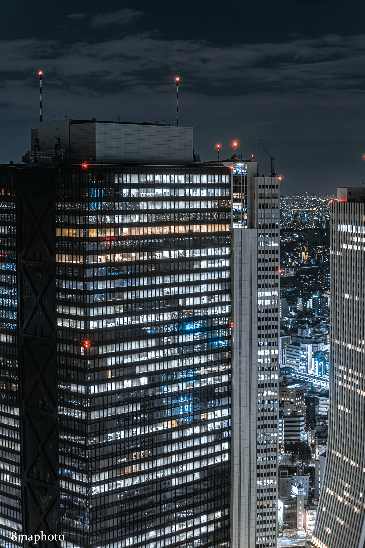 Night city skyline with illuminated skyscrapers