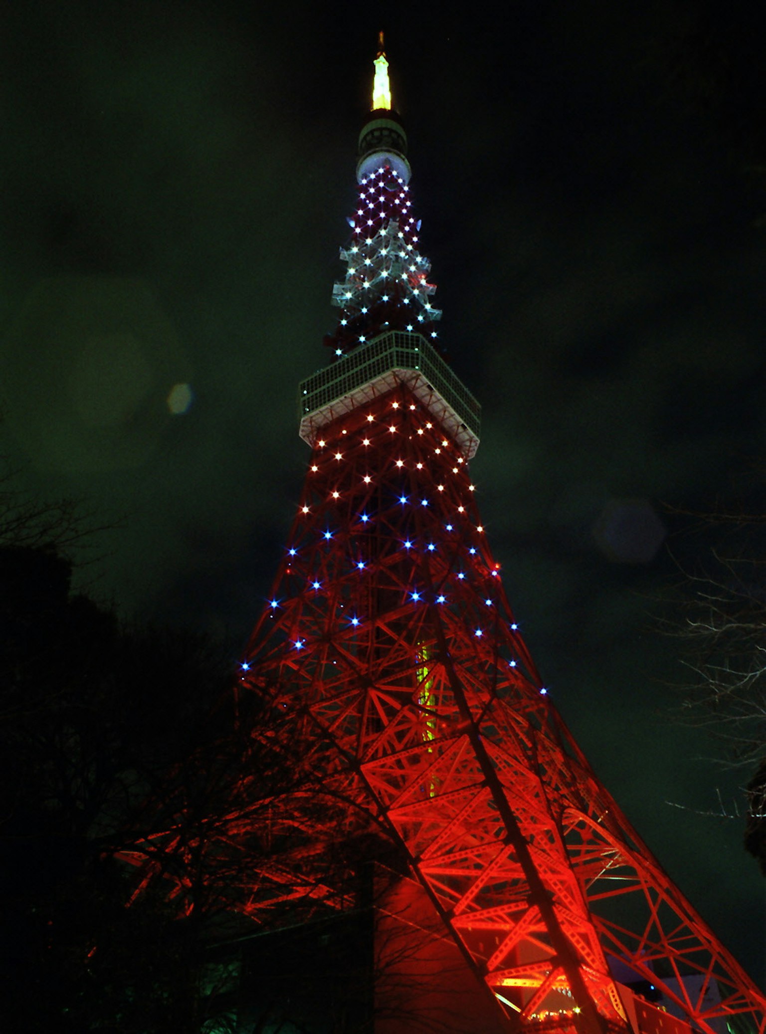 Tokyo Tower at night illuminated with red and blue lights