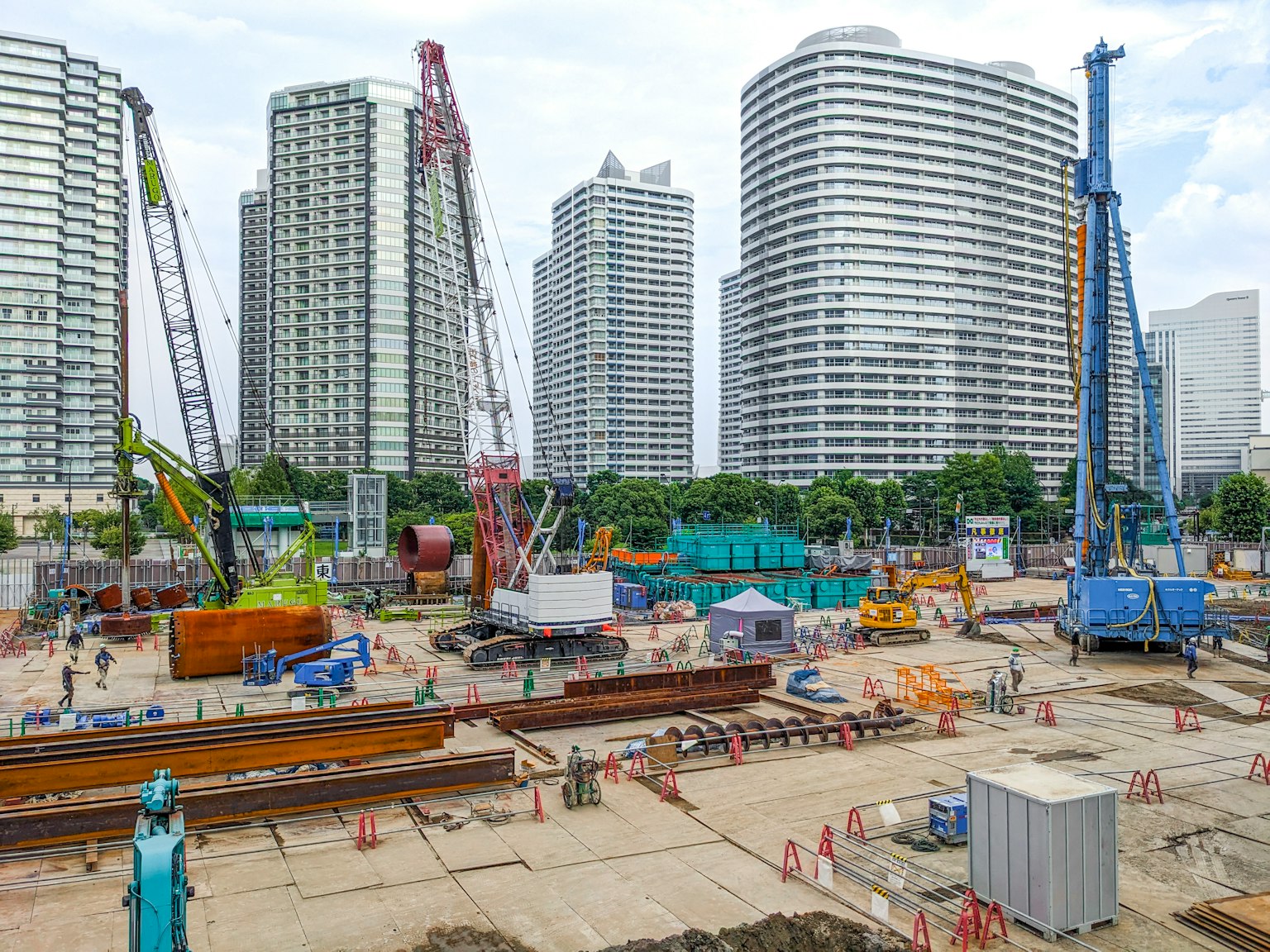 Construction site with high-rise buildings cranes and machinery in operation