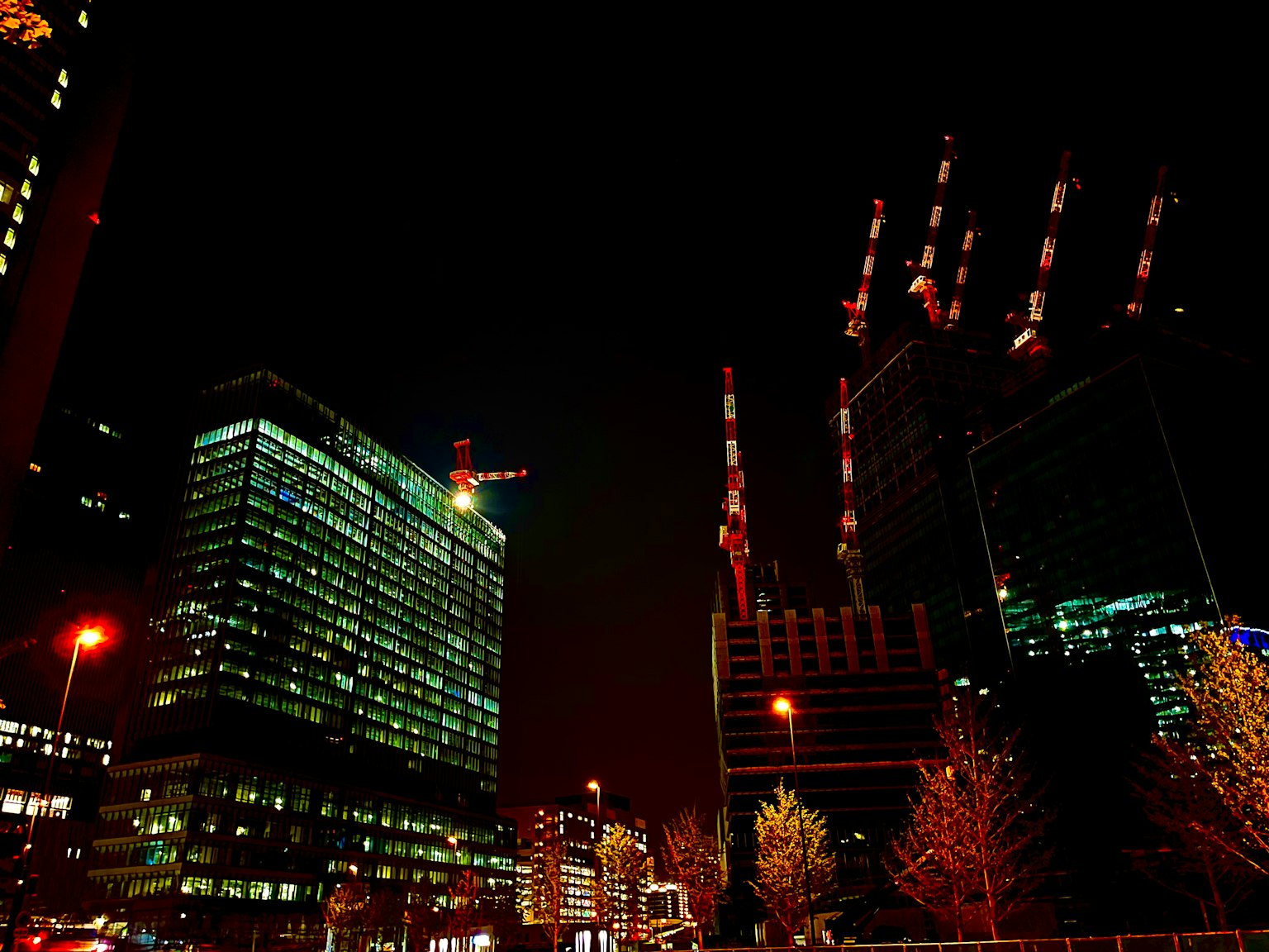 Paysage urbain nocturne avec des gratte-ciels et des grues