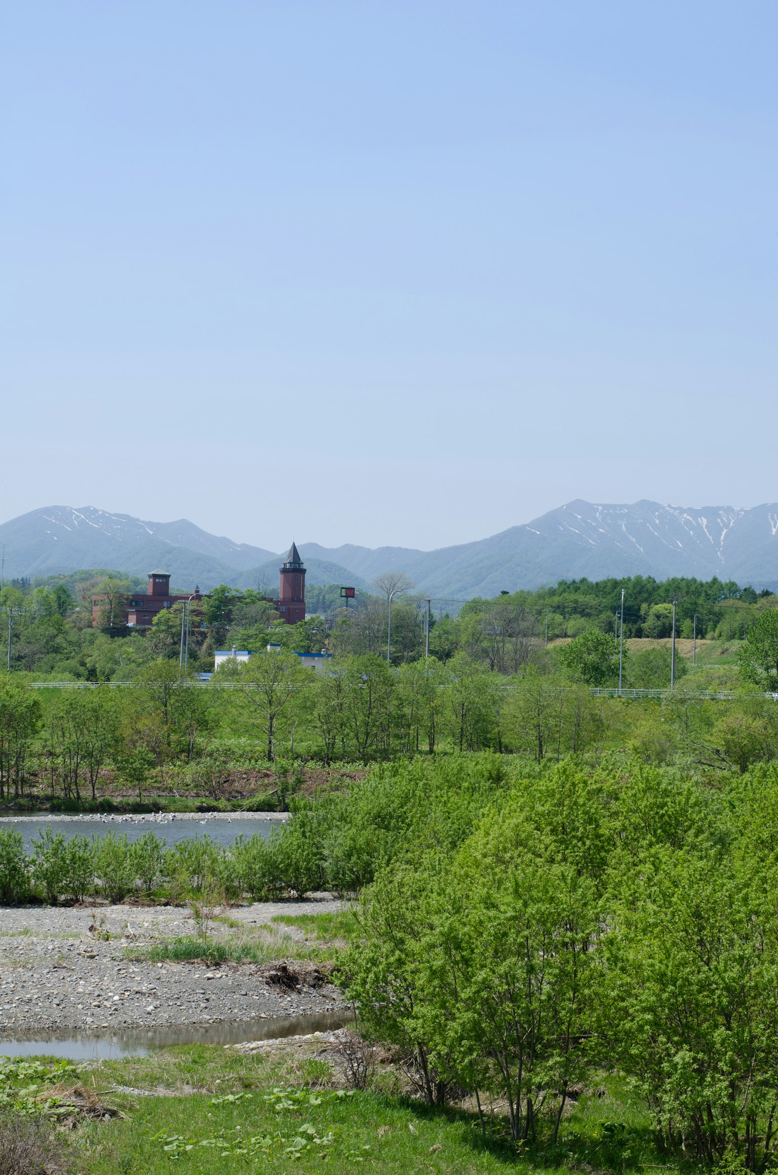 Scenic view of mountains and river surrounded by lush greenery