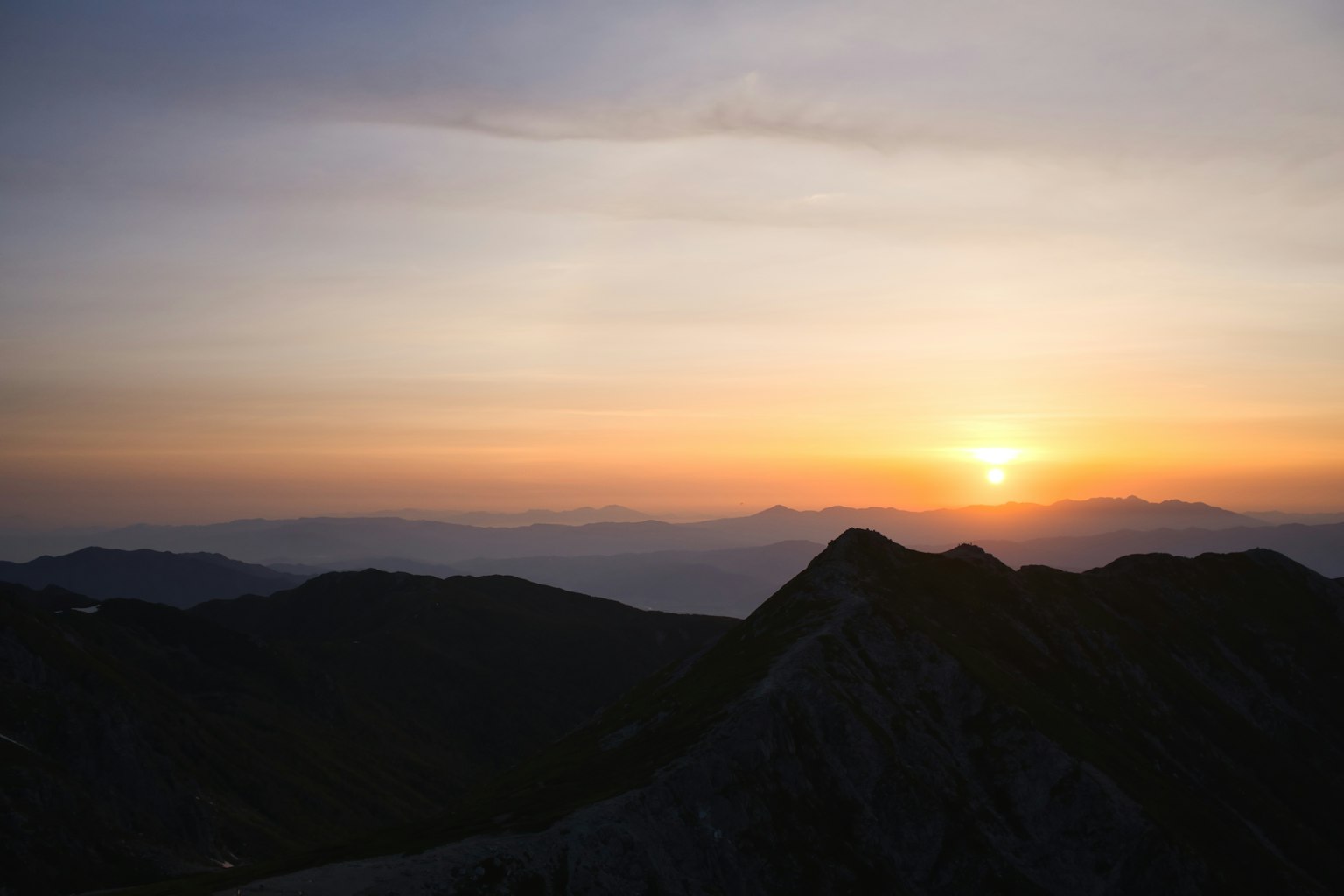 Beautiful sunset over mountains with silhouettes