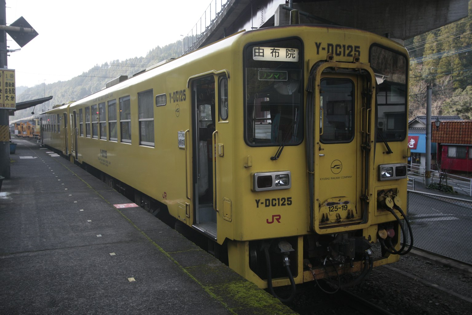 A yellow train parked at a station