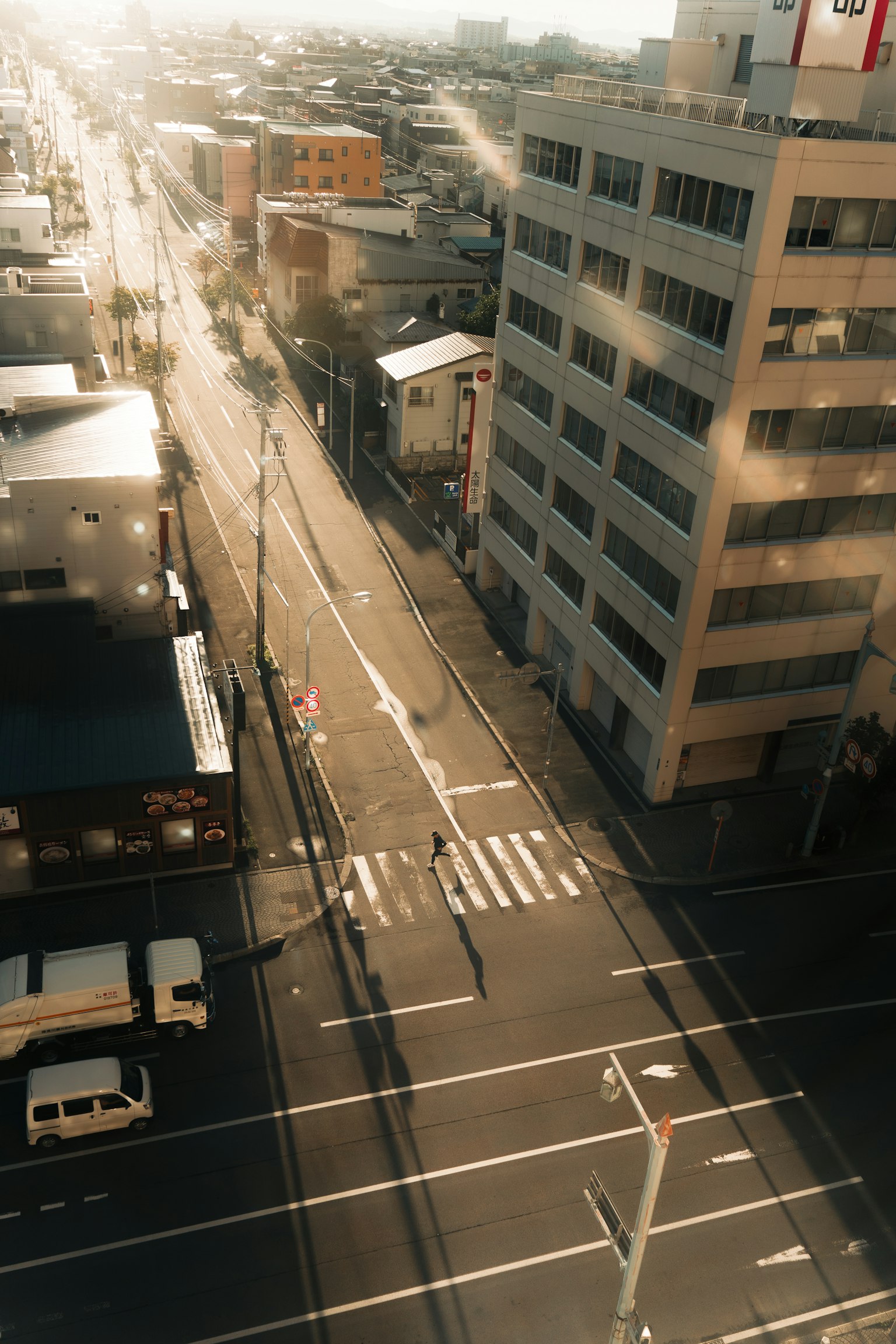 Urban landscape featuring a tall building and crosswalk