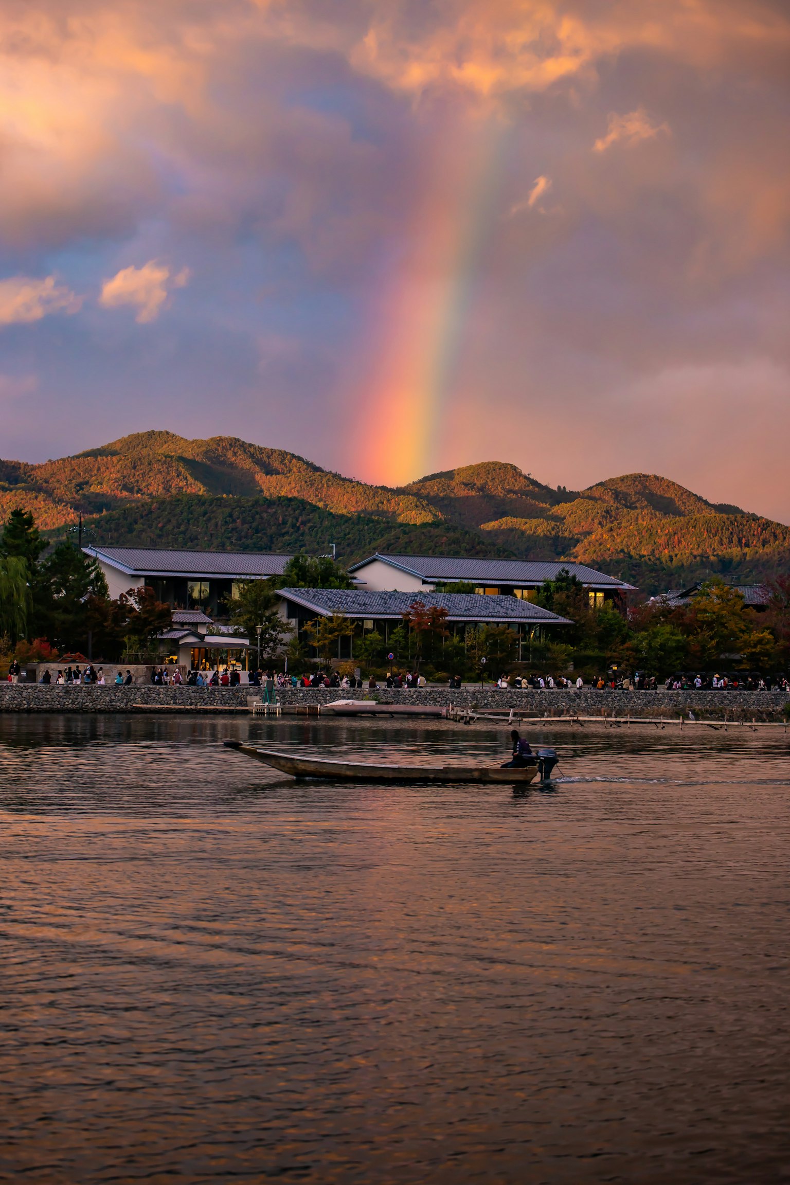 Scenic view of a rainbow over mountains and a river
