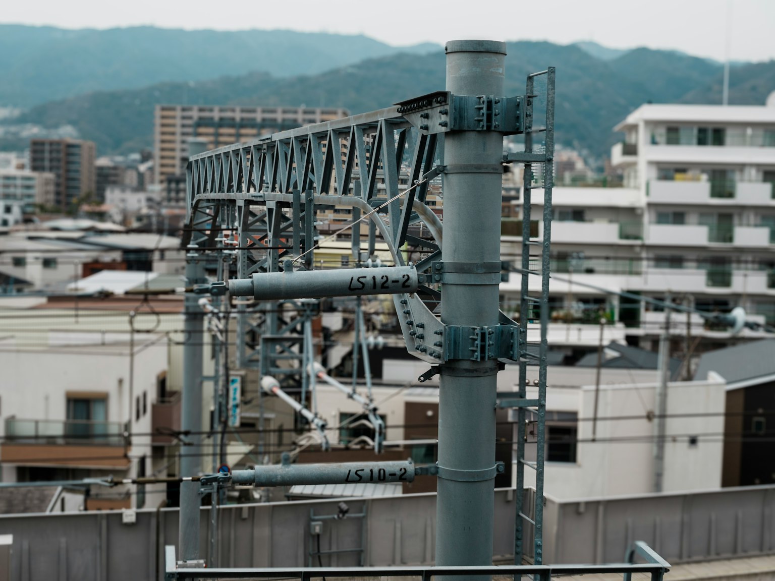Urban railway overhead line with buildings in the background