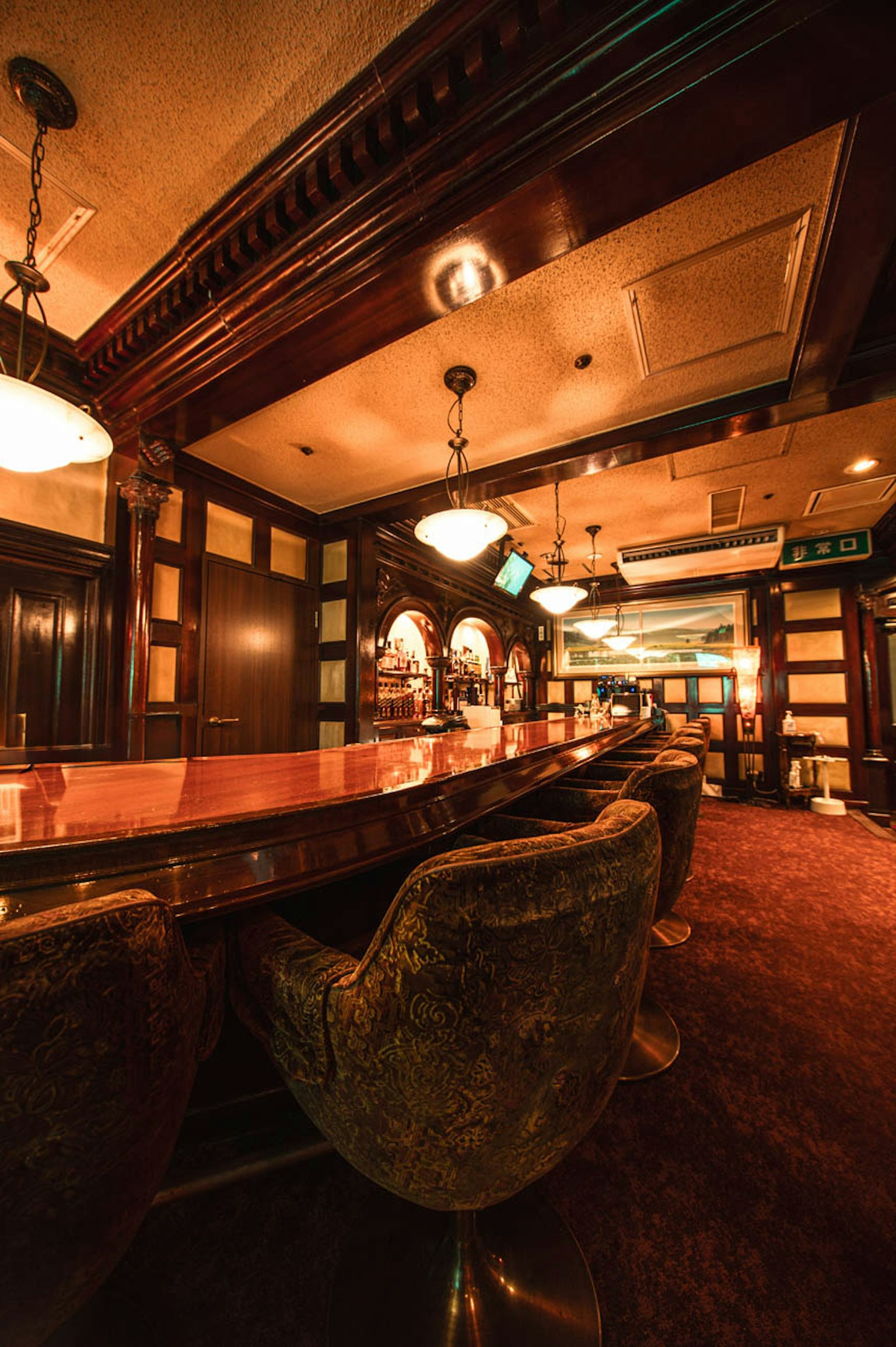 Elegant bar interior with wooden decor plush seating and soft lighting