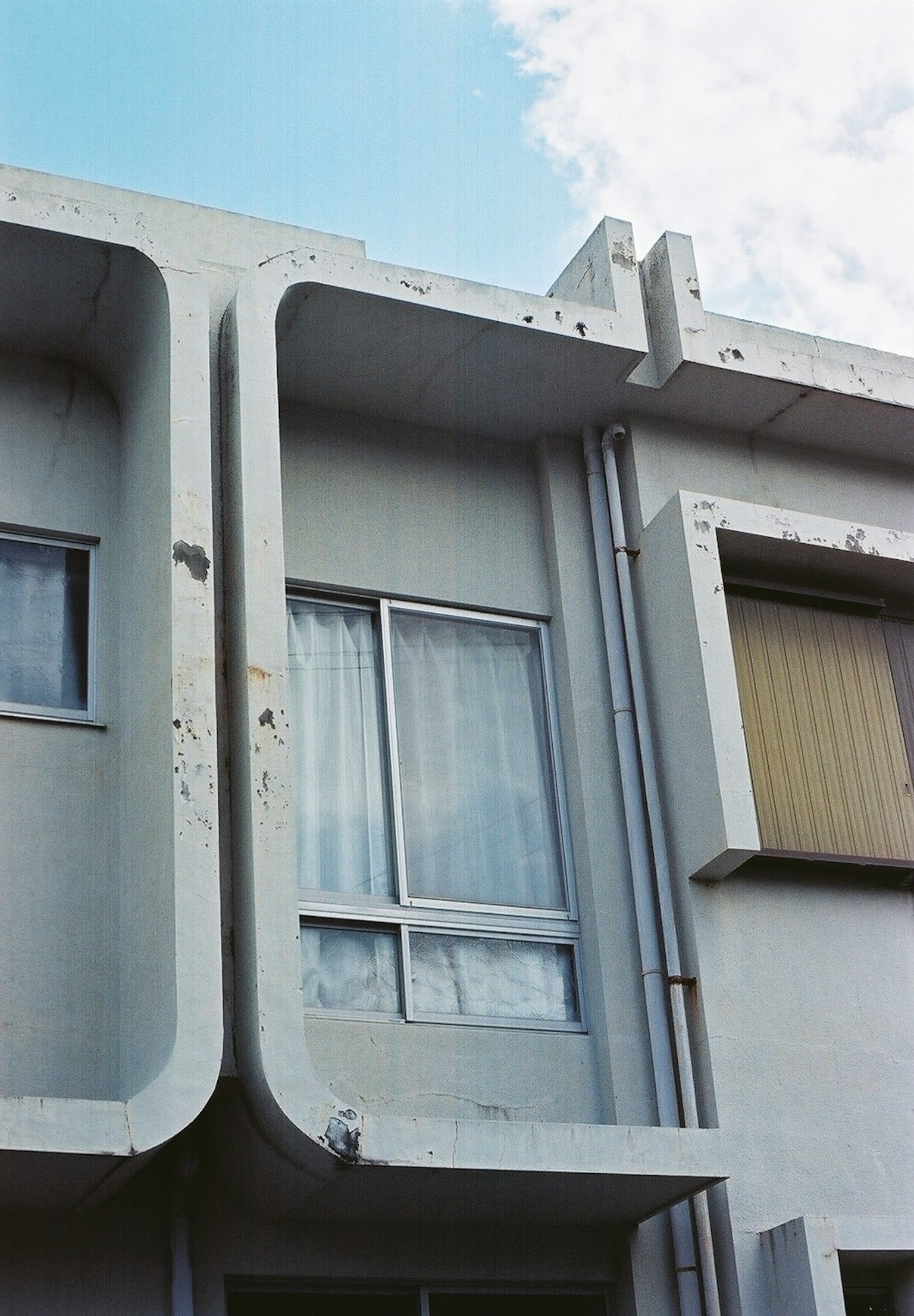 Part of a modern building with white exterior and large window