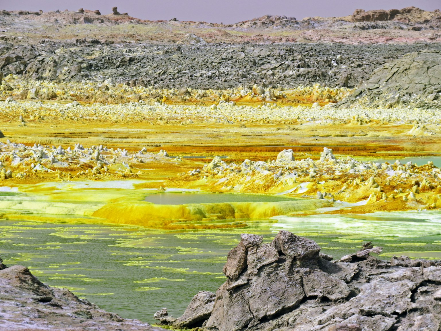 Unique landscape with vibrant yellow-green water and rocks