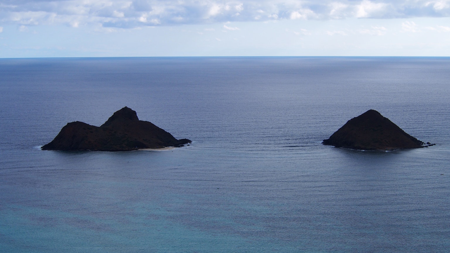 Two small islands floating in the ocean