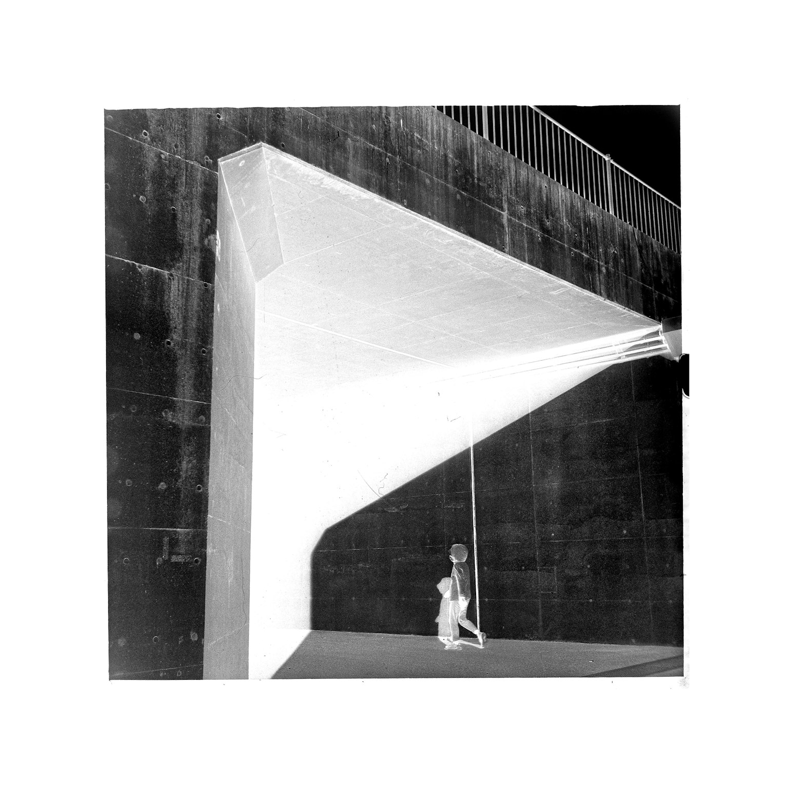 A person standing in front of an abstract structure in black and white