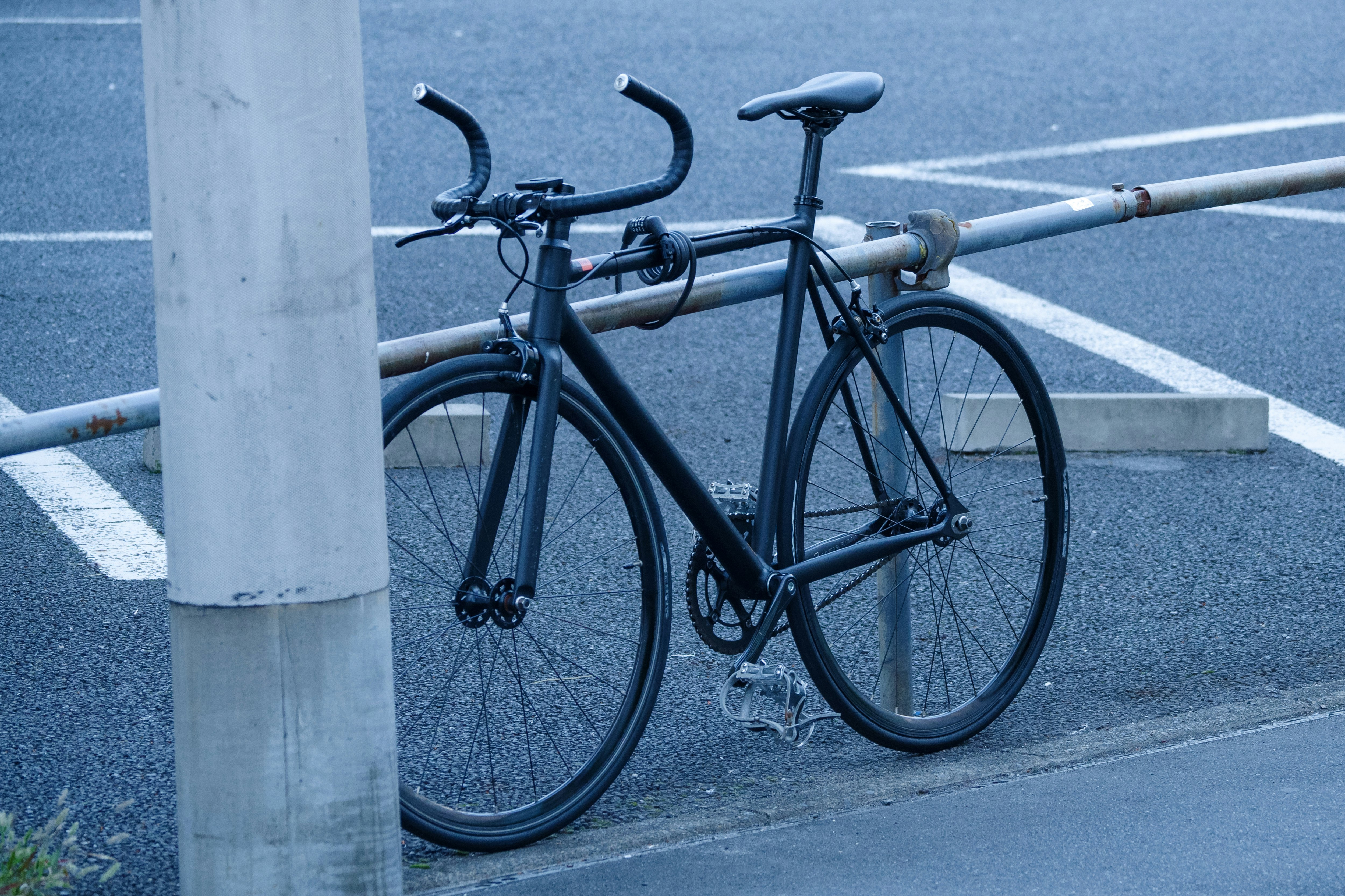 bicycles parked beside a street pole