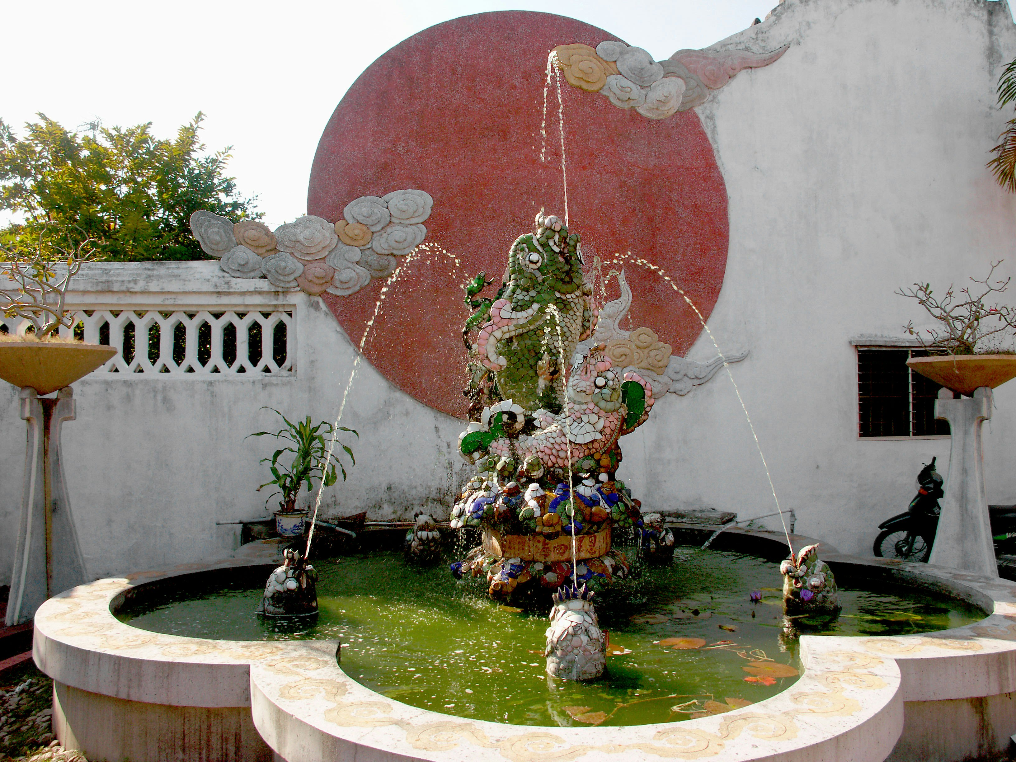 courtyard fountain with a red circular wall decoration
