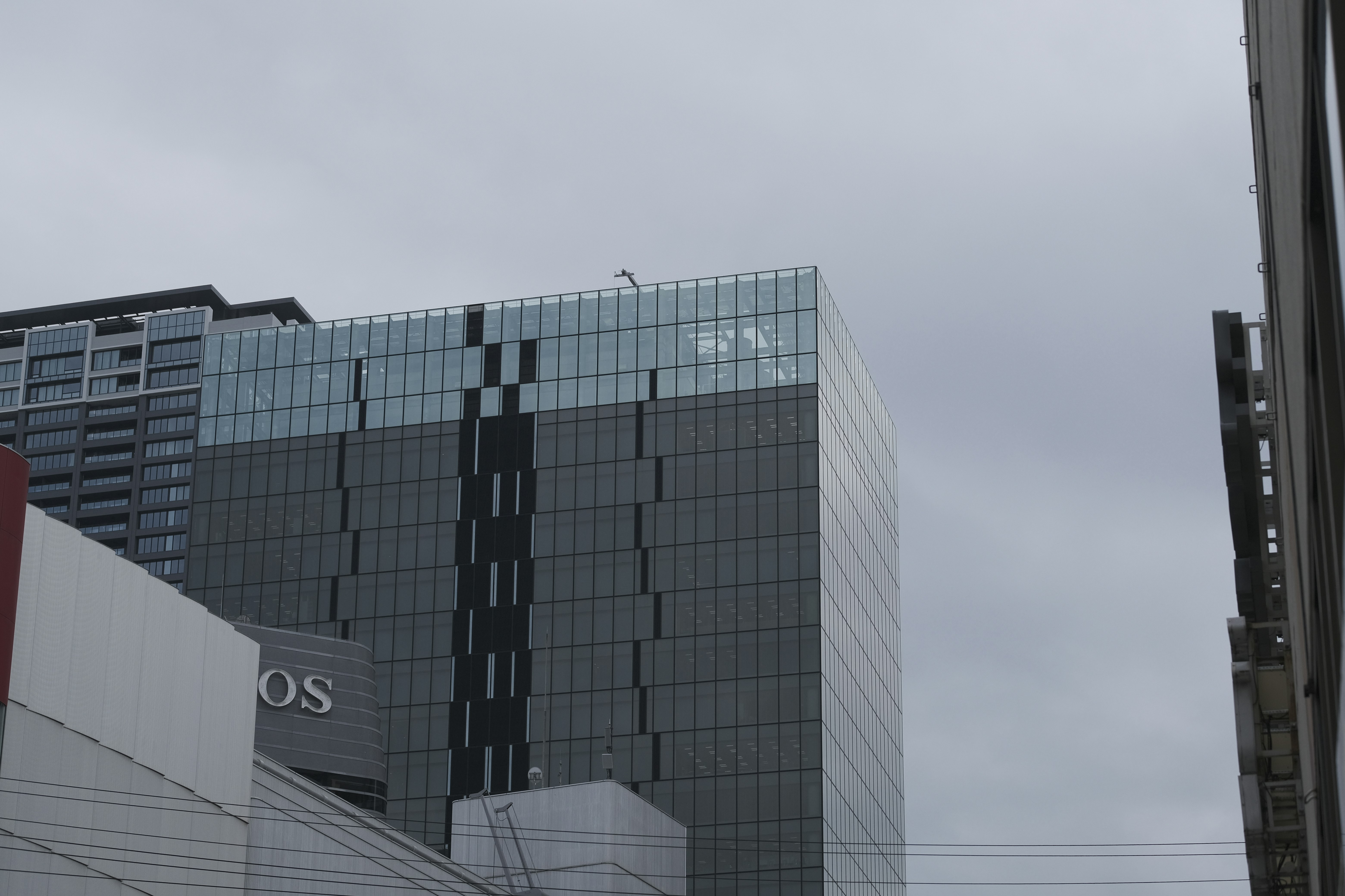 glass skyscraper facade in an overcast cityscape