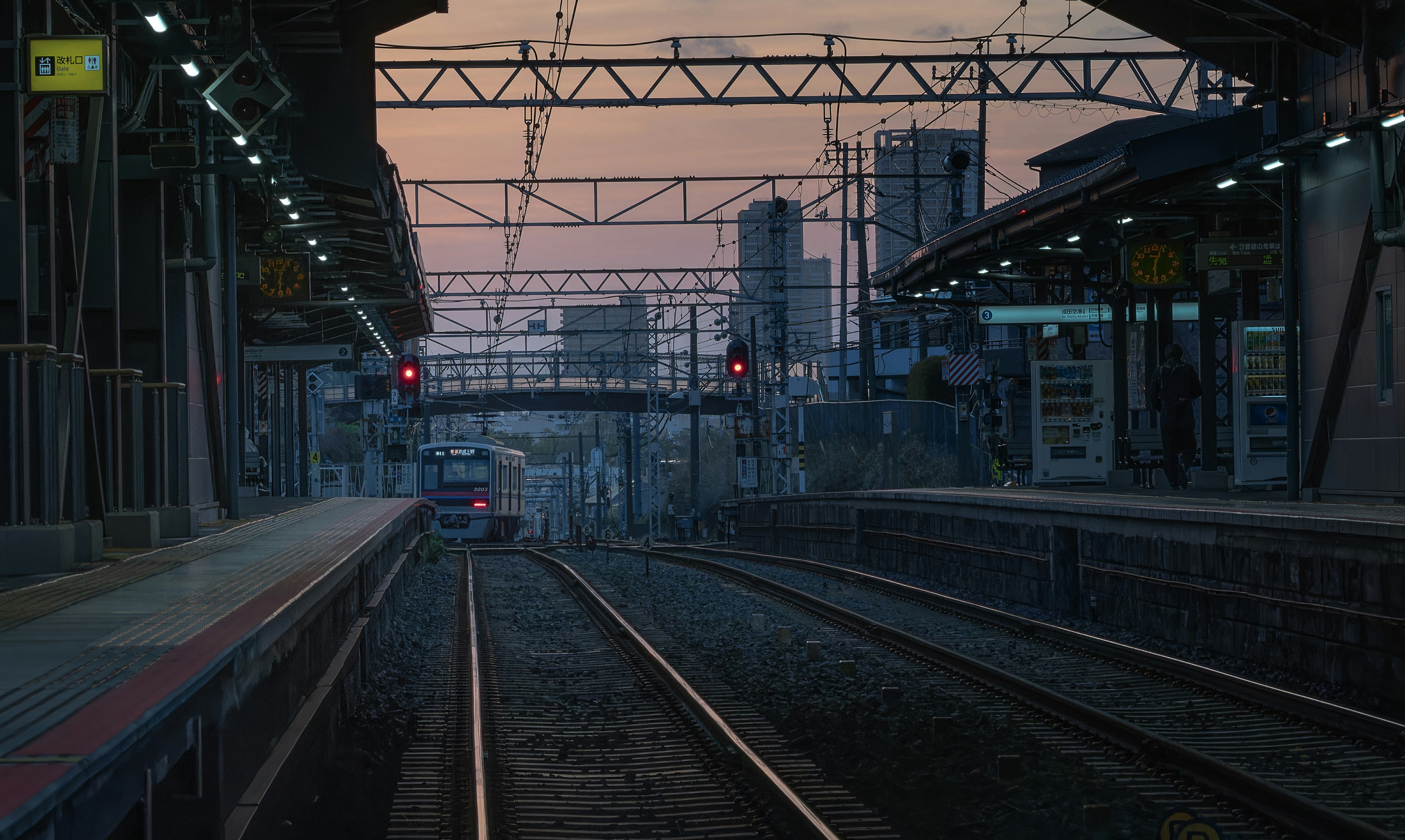 Dusk train tracks and station platform scene
