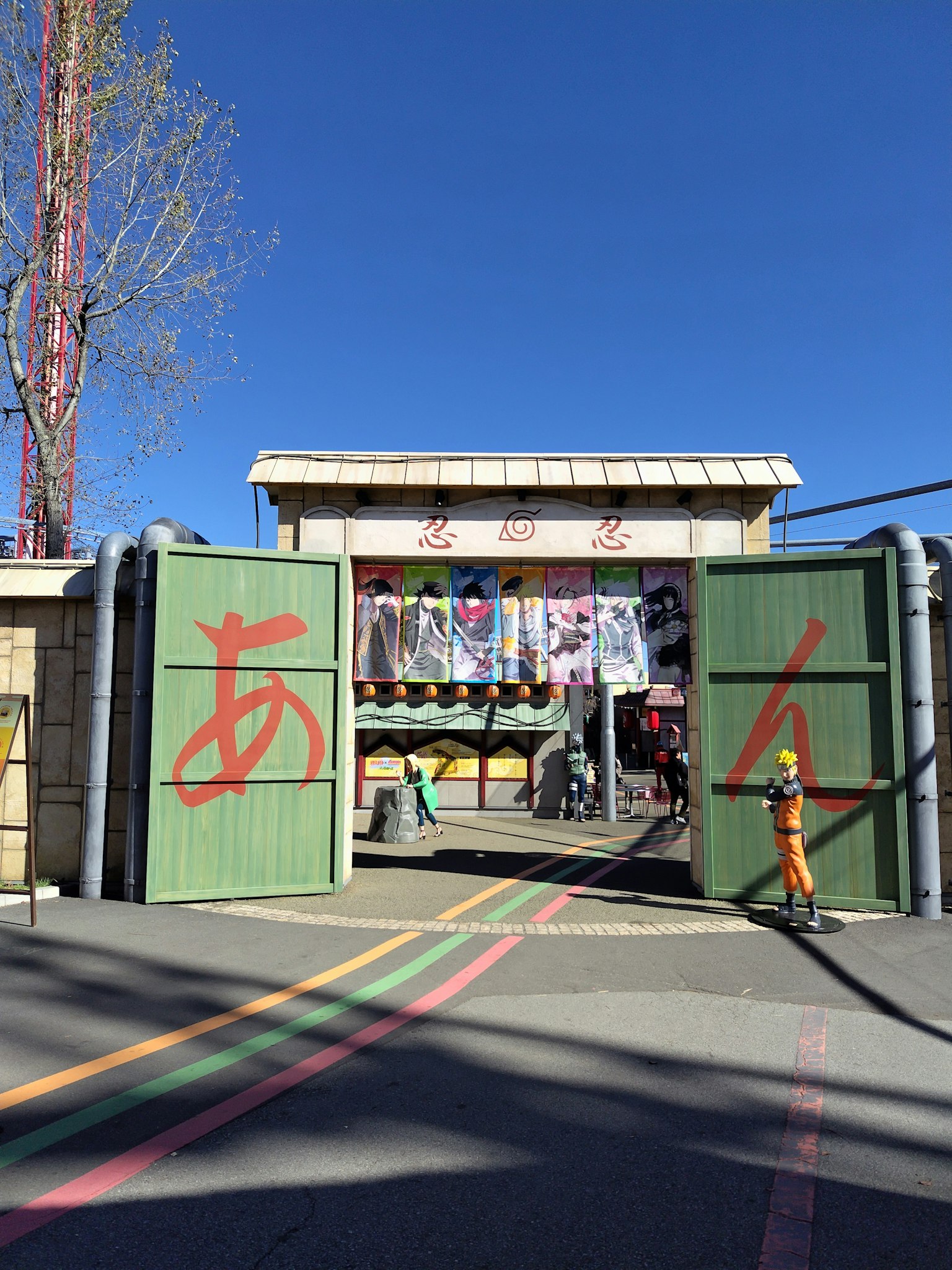 Vibrant entrance with green gates colorful fabric decorations visible in the background
