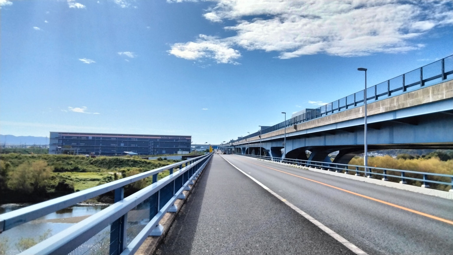 Open road and bridge view under blue sky