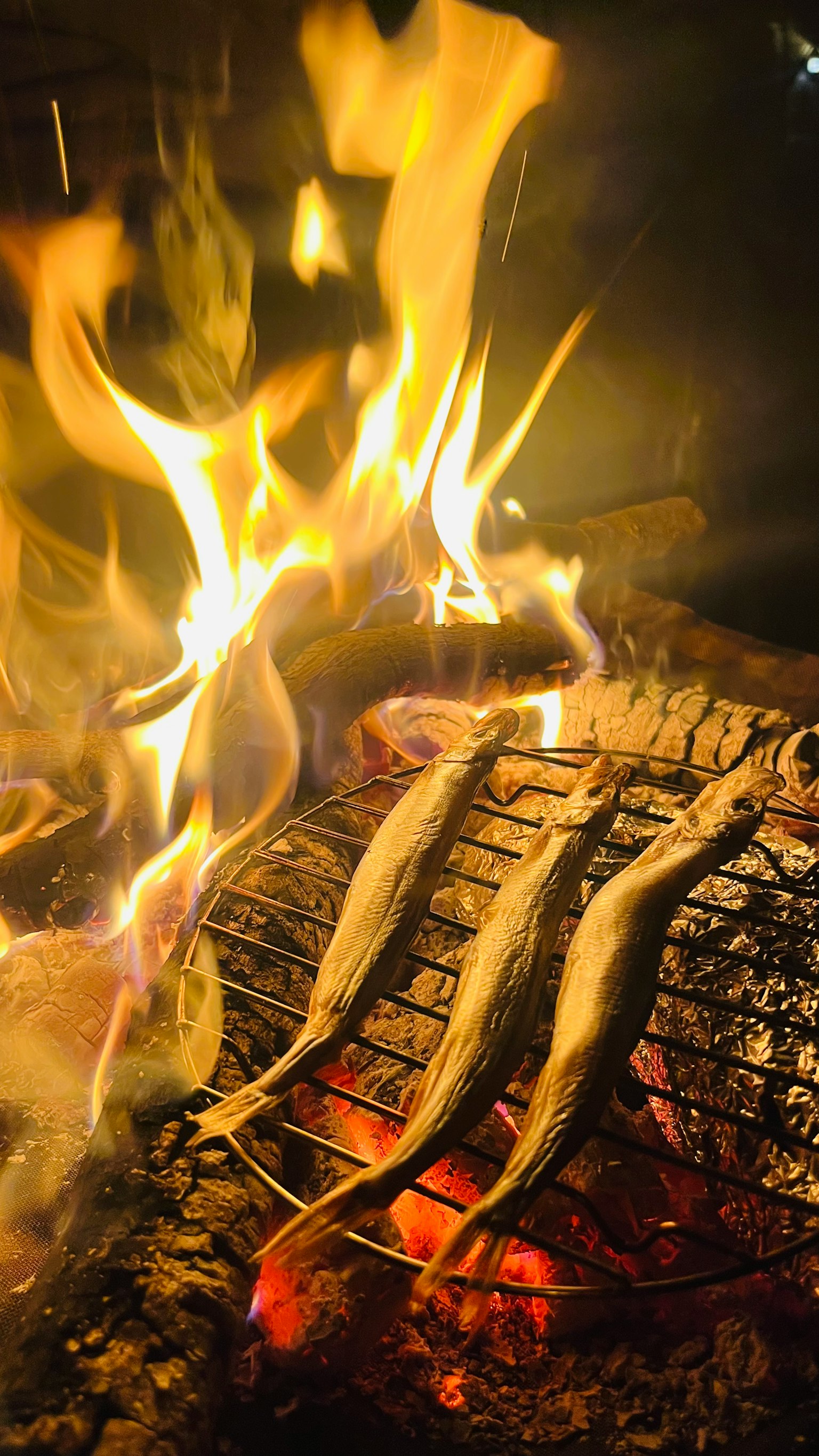 Grilled fish skewers over an open flame