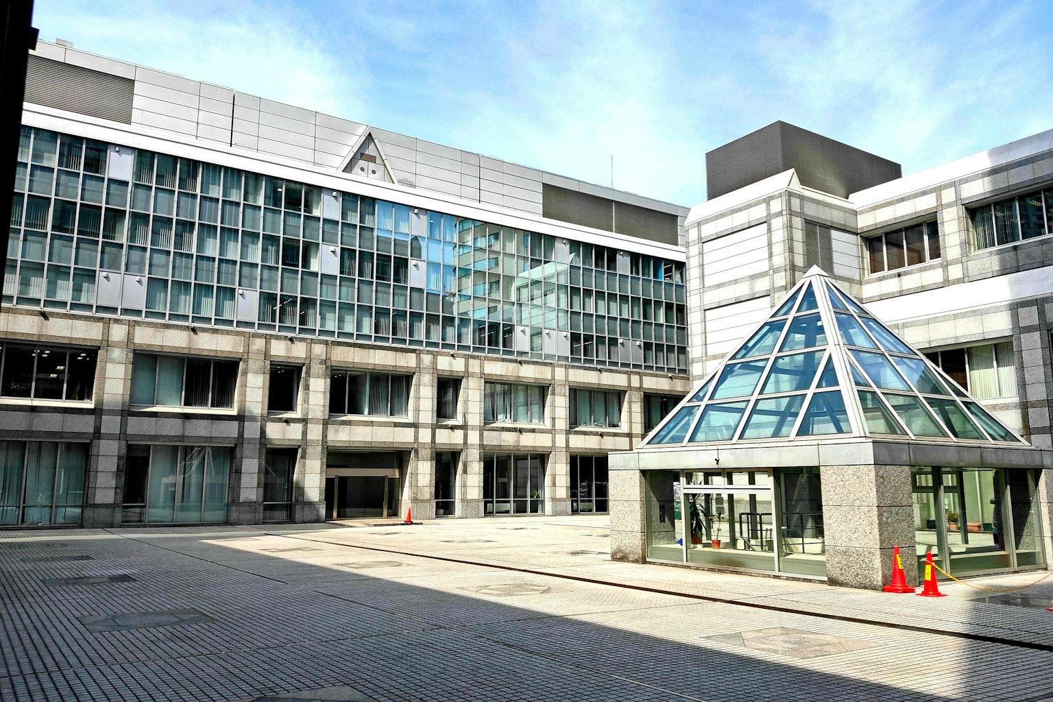 Modern building exterior with glass pyramid roof