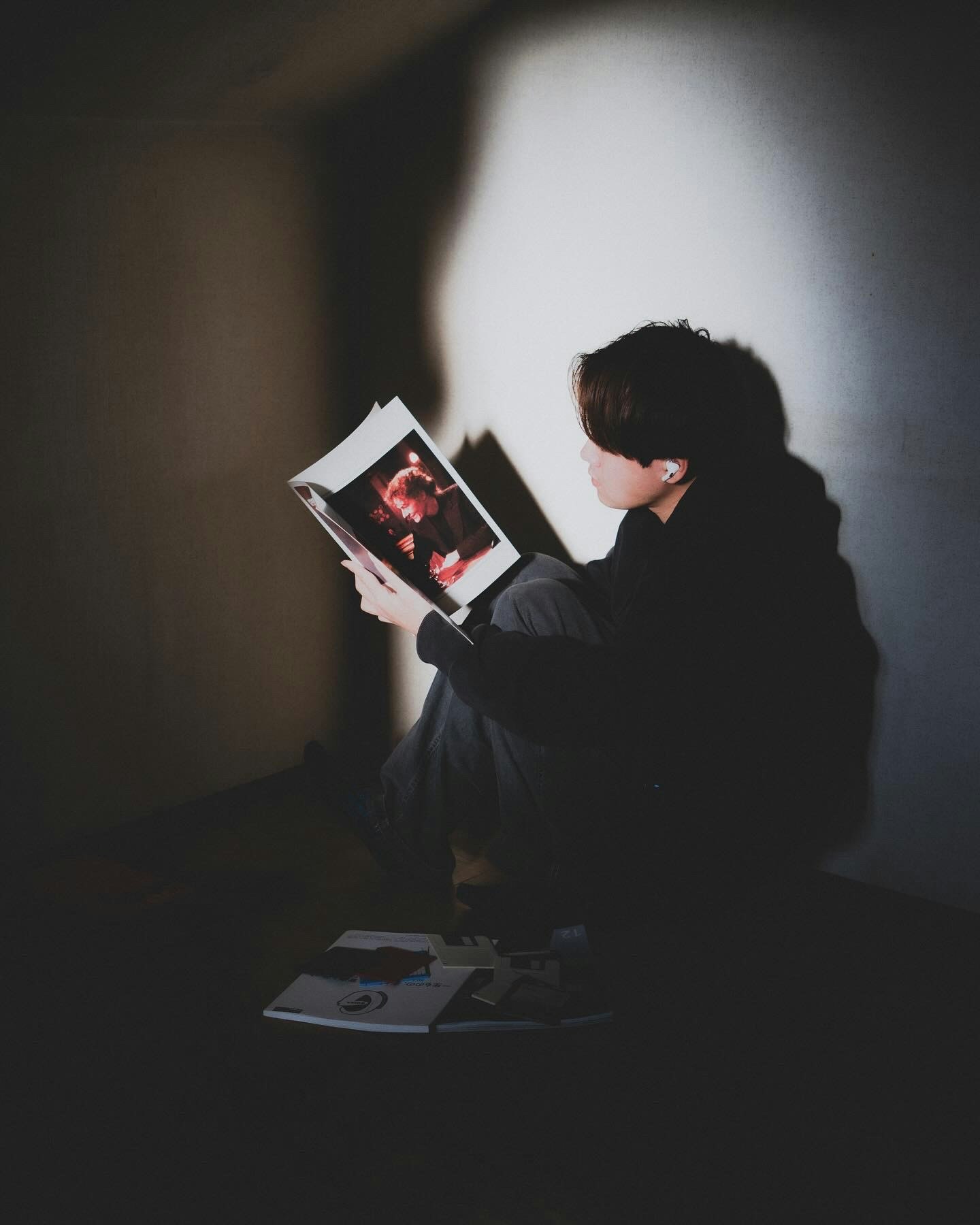 child reading a magazine in a dark studio