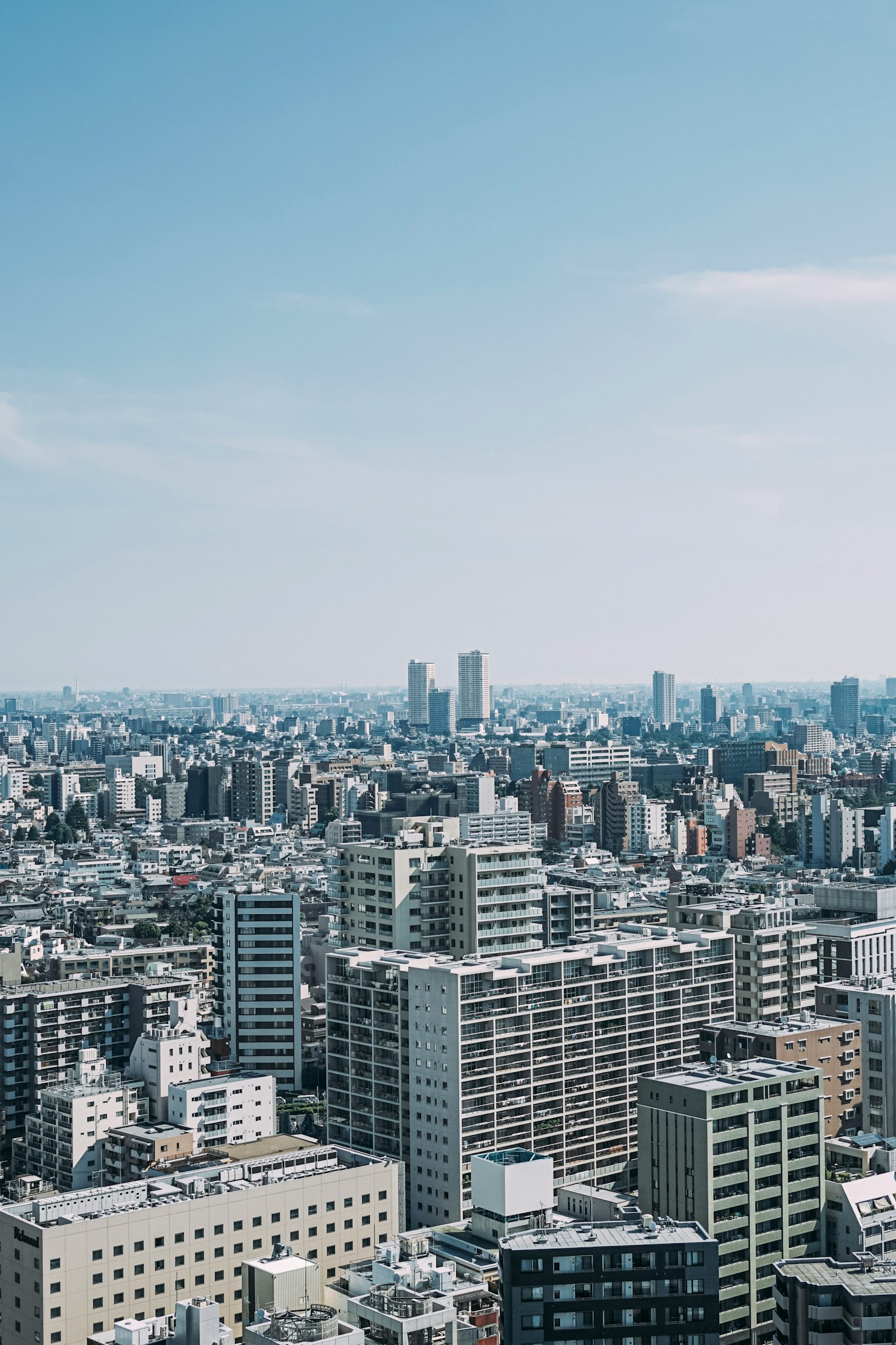 Cityscape of Tokyo with skyscrapers under a clear blue sky