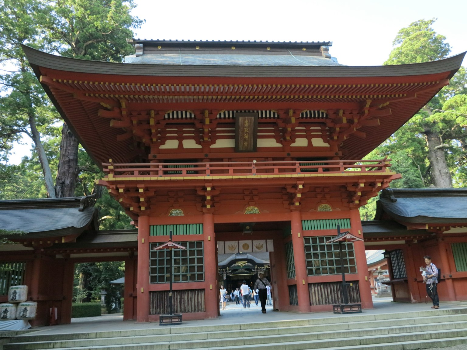 Traditional Japanese shrine entrance featuring a beautiful red gate and intricate architecture