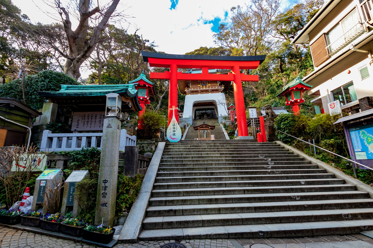 Stairway leading to a shrine with a prominent red torii gate