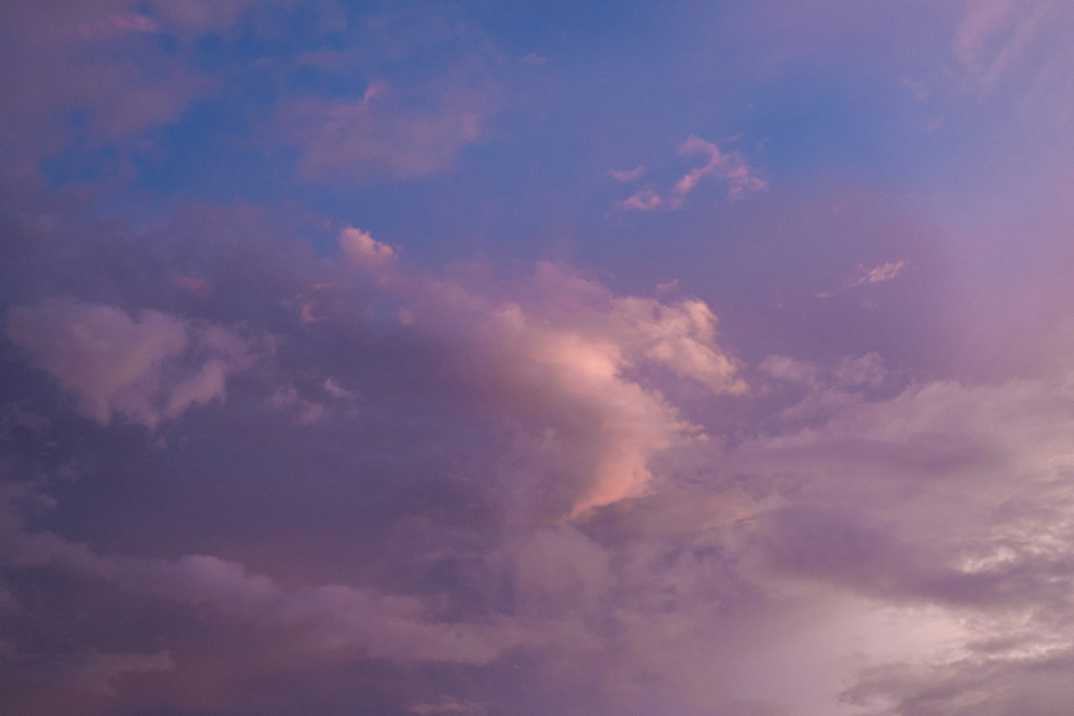 A landscape featuring blue-purple sky with pink clouds