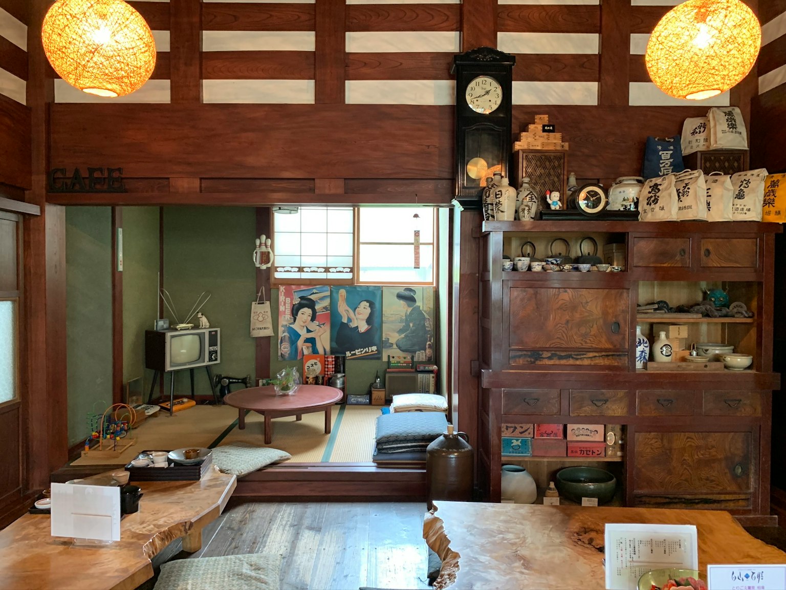 Traditionelles japanisches Wohnzimmer mit Holzmöbeln und Dekor mit traditionellen Gemälden an den Wänden