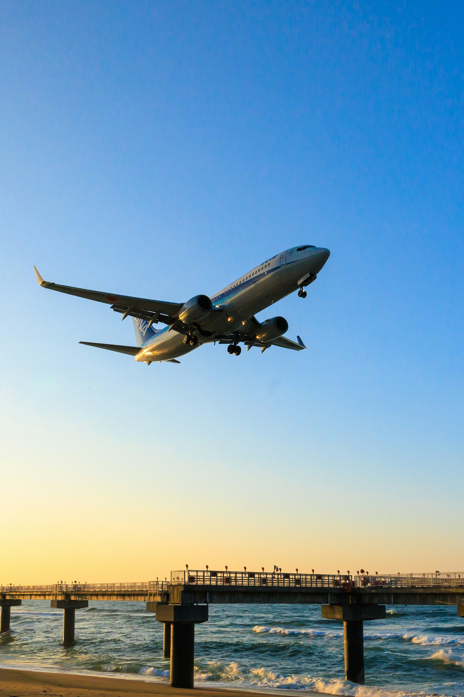 Aereo che sorvola l'oceano al tramonto