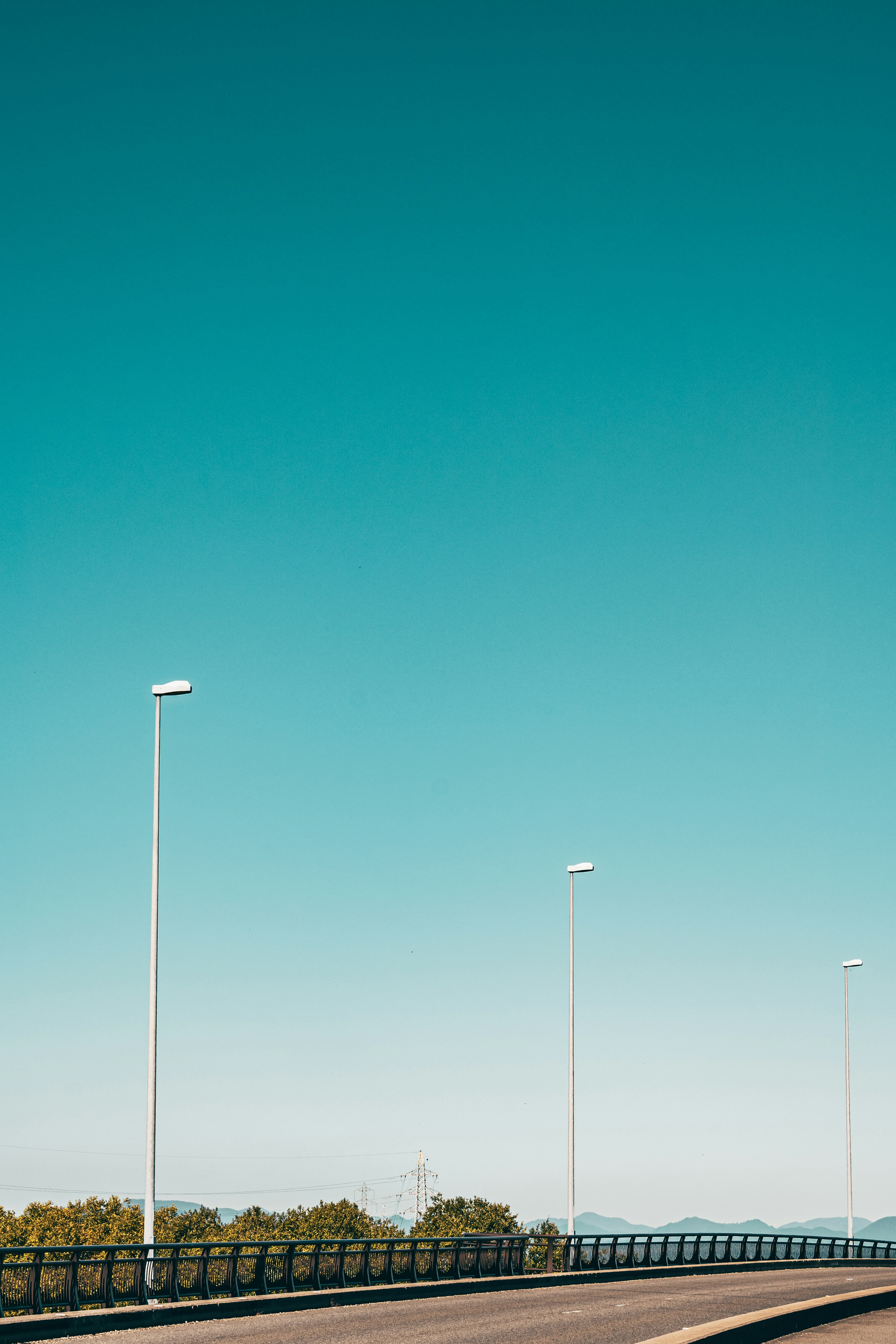 elevated walkway with streetlights under a clear blue sky