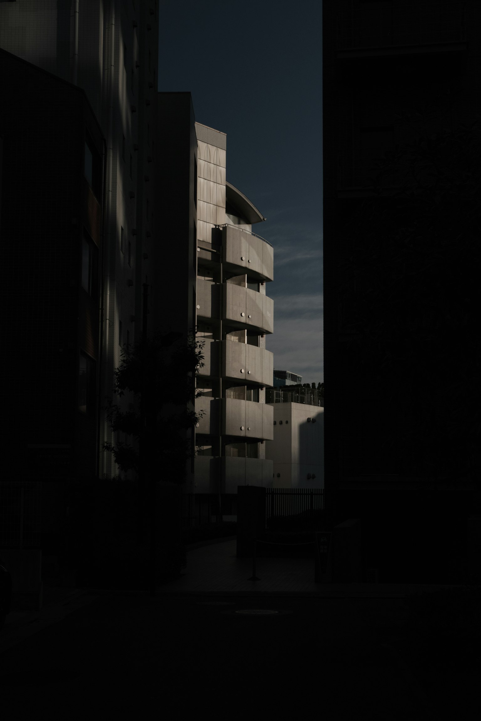 Silhouette of a modern building in a dark alley