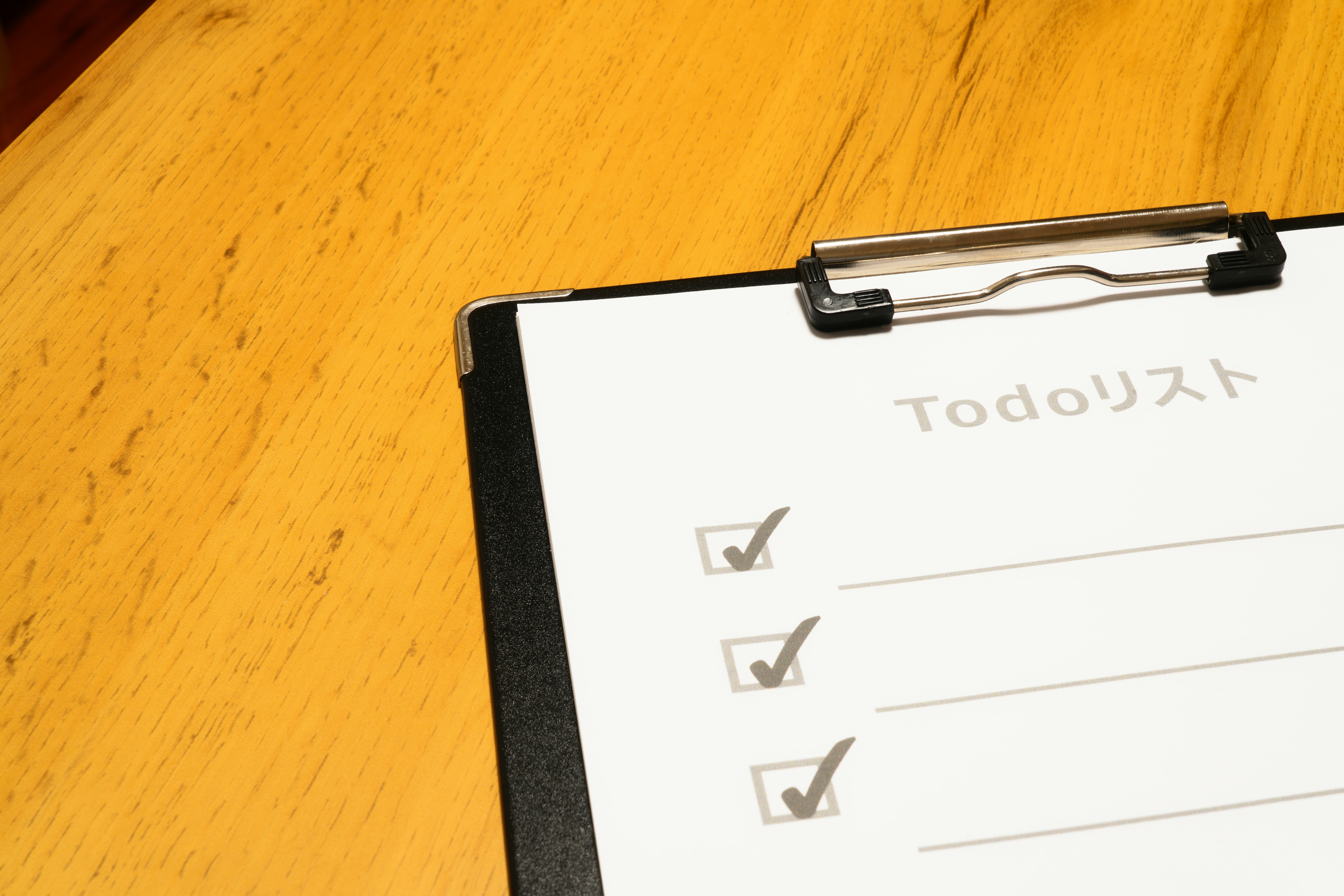 clipboard with a checklist on a wooden desk