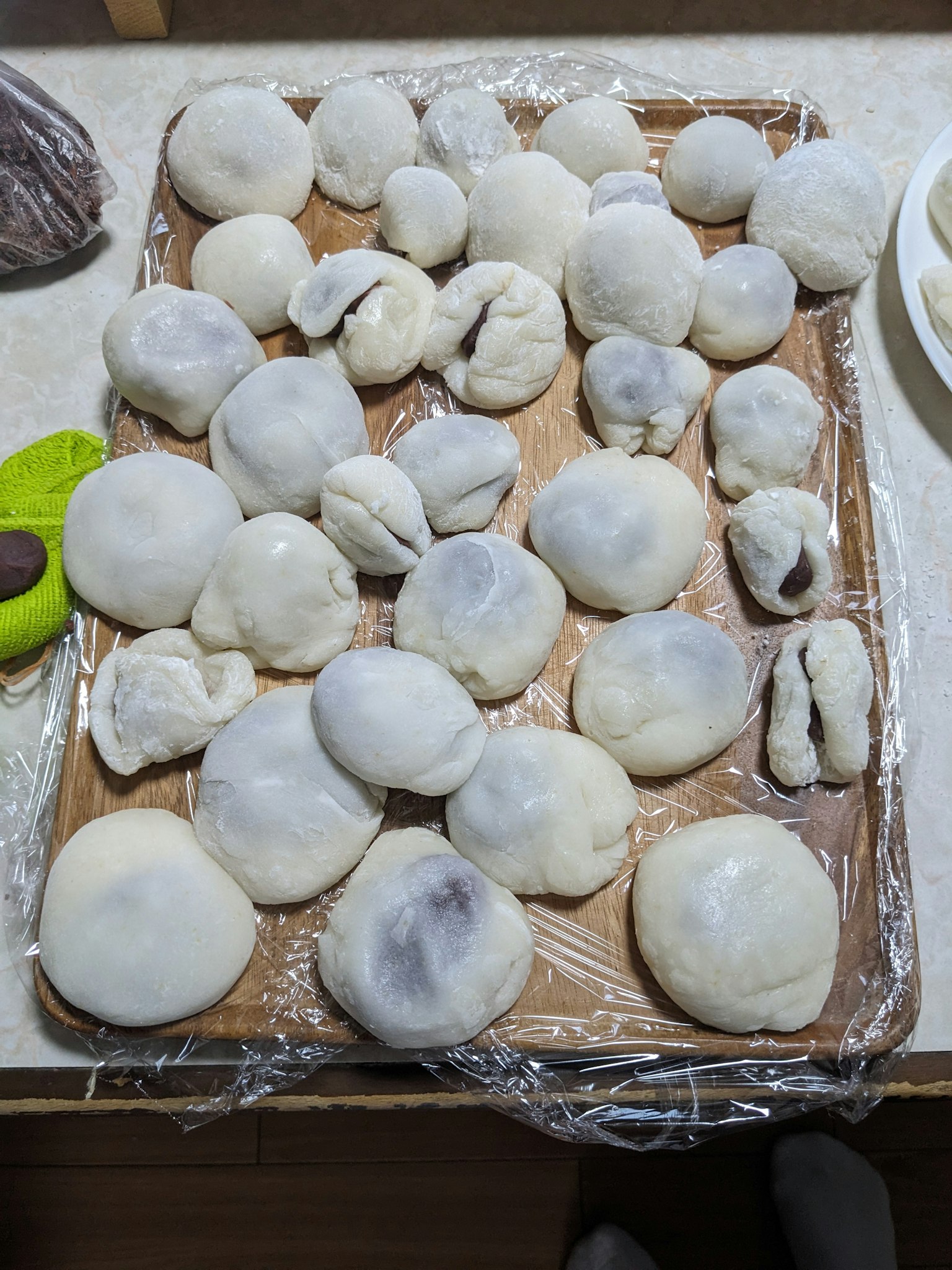 Tray of white mochi balls arranged on a wooden surface