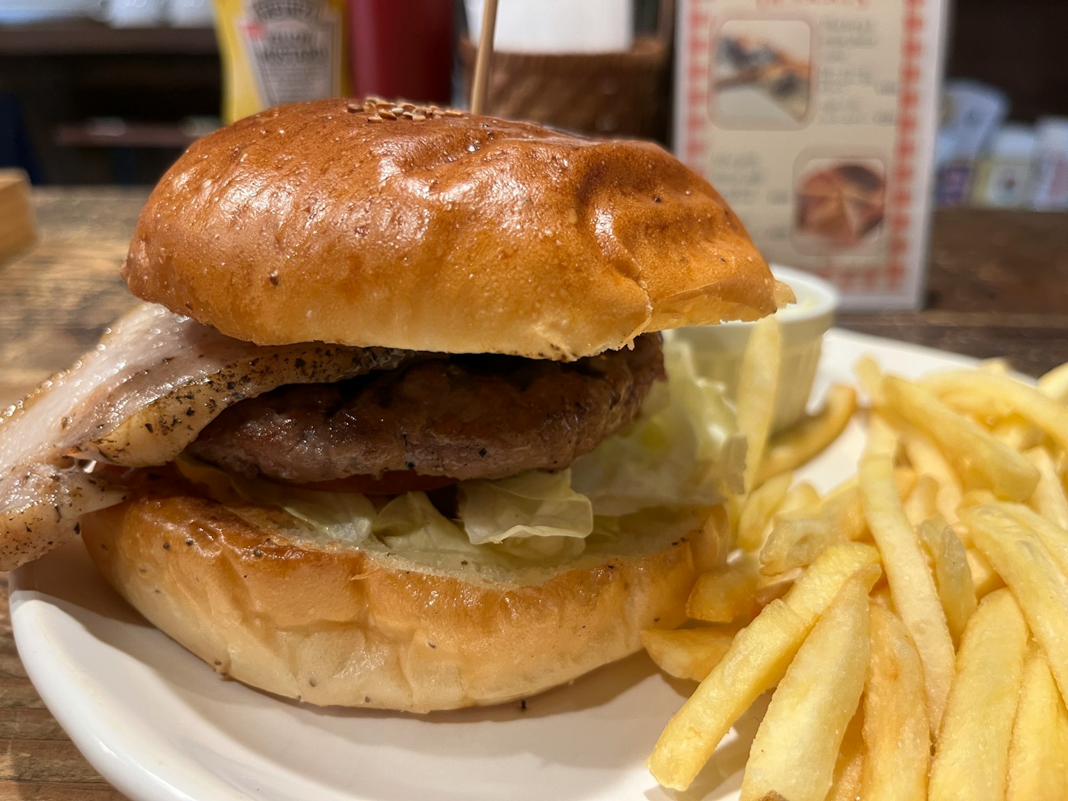 Delicious hamburger with lettuce and fries on a plate