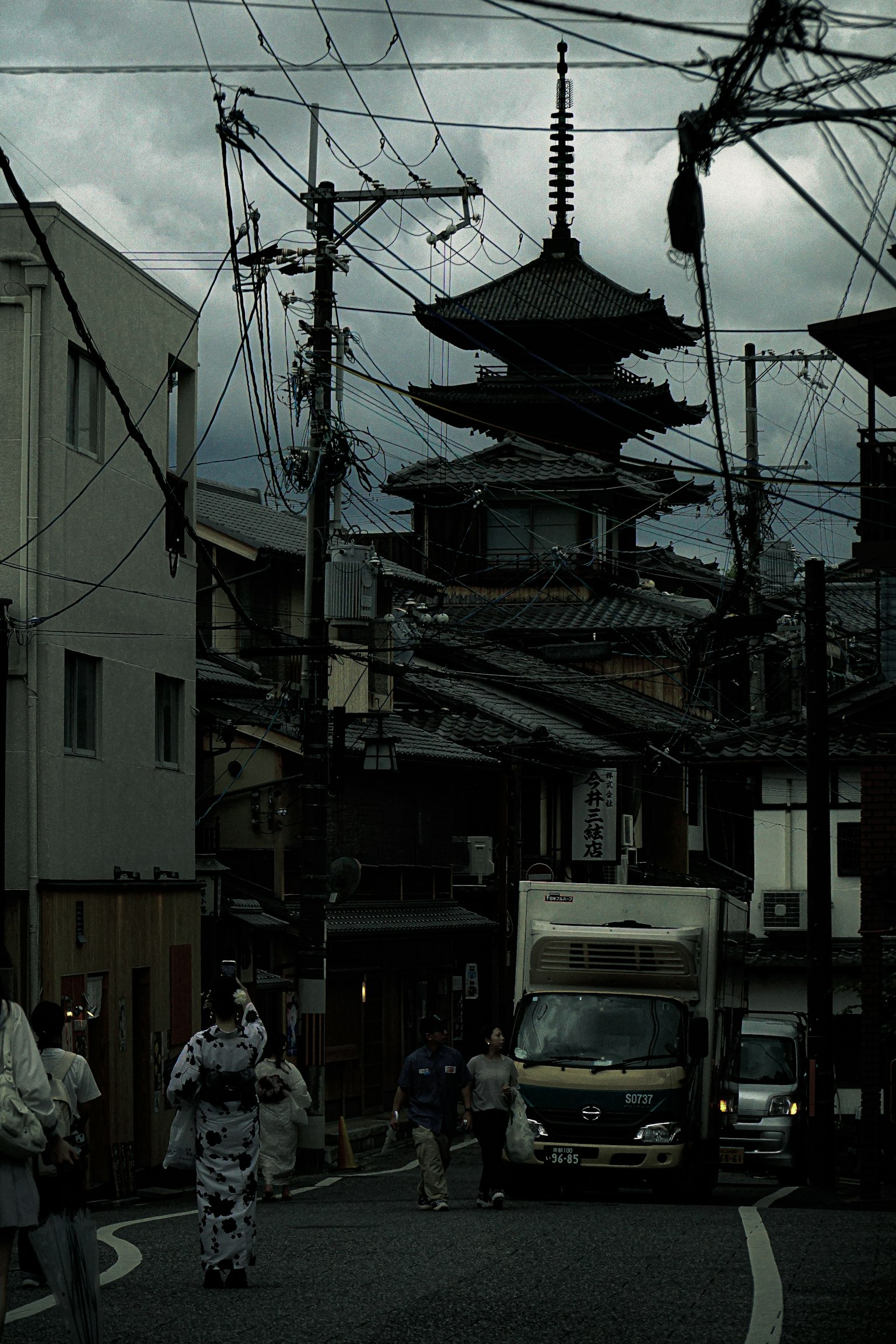 Pagode japonaise traditionnelle et scène de rue sous un ciel sombre