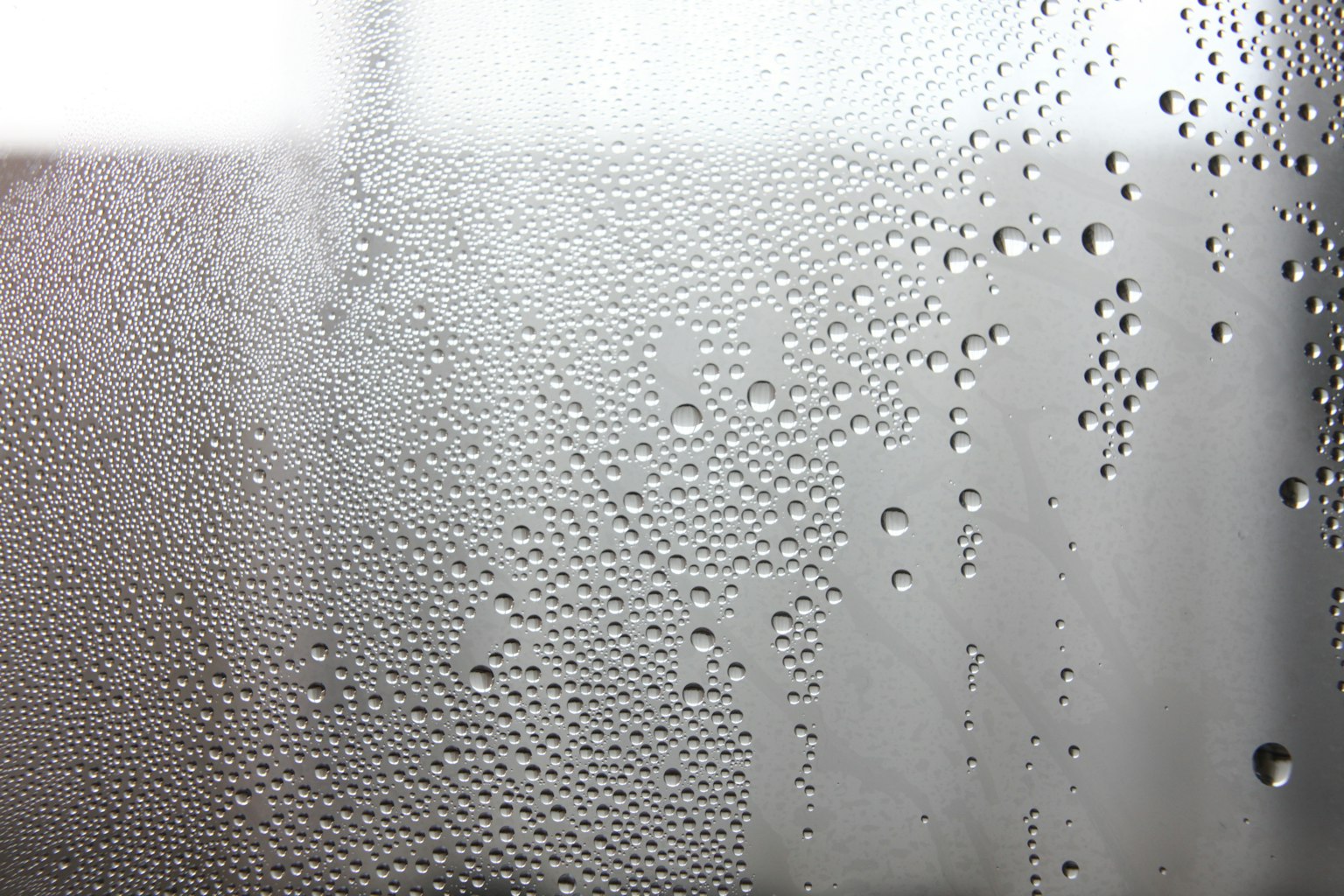 Condensation on a window with water droplets forming