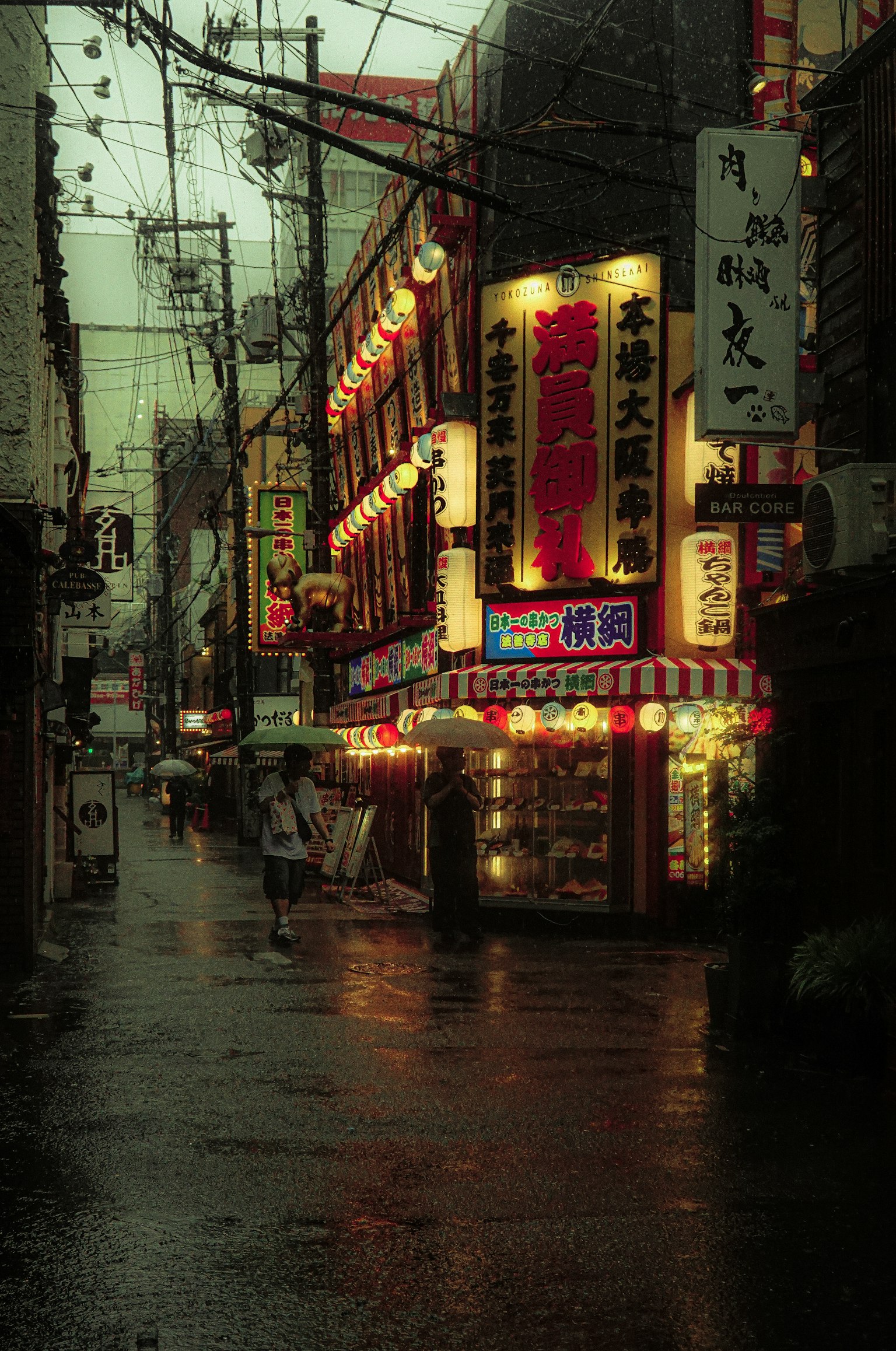 비 오는 날의 활기찬 상점 거리 장식된 간판과 다채로운 등불이 늘어서 있다