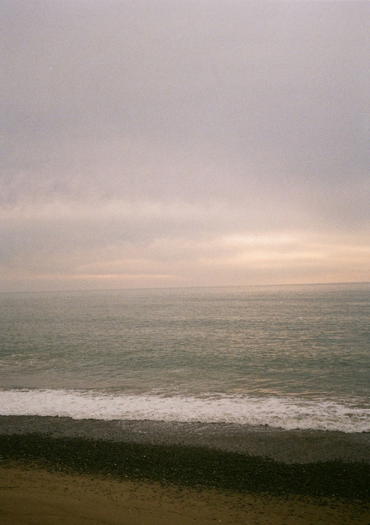 Calm sea and cloudy sky landscape waves lapping the shore