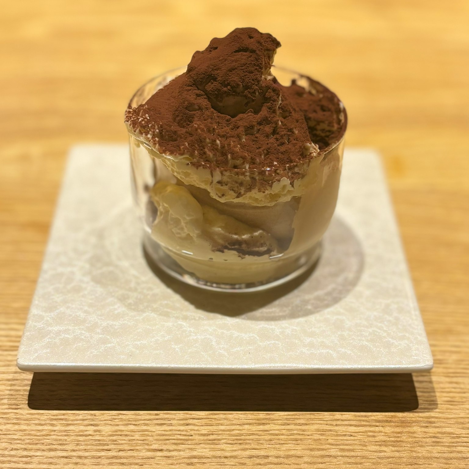 Creamy tiramisu dessert served in a glass cup