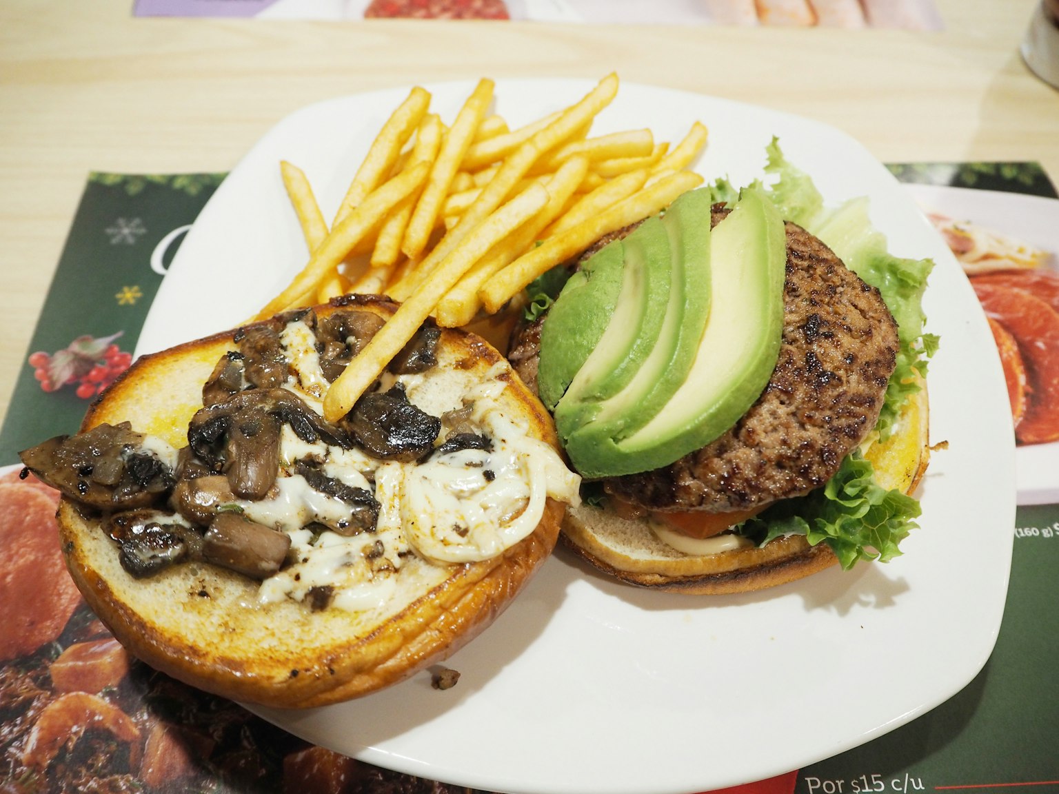 Avocado and lettuce burger with fries on a plate