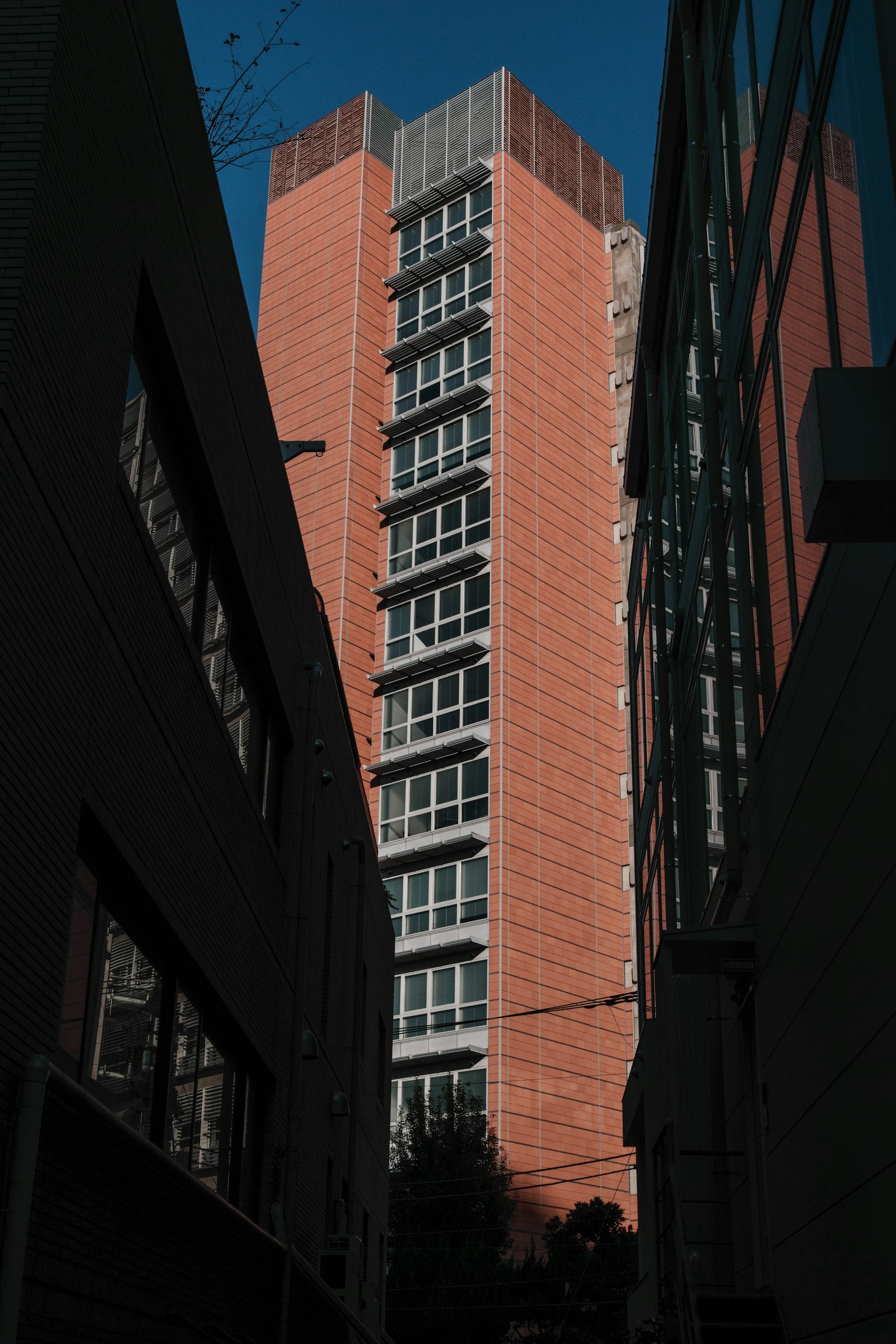 A tall building stands between narrow streets
