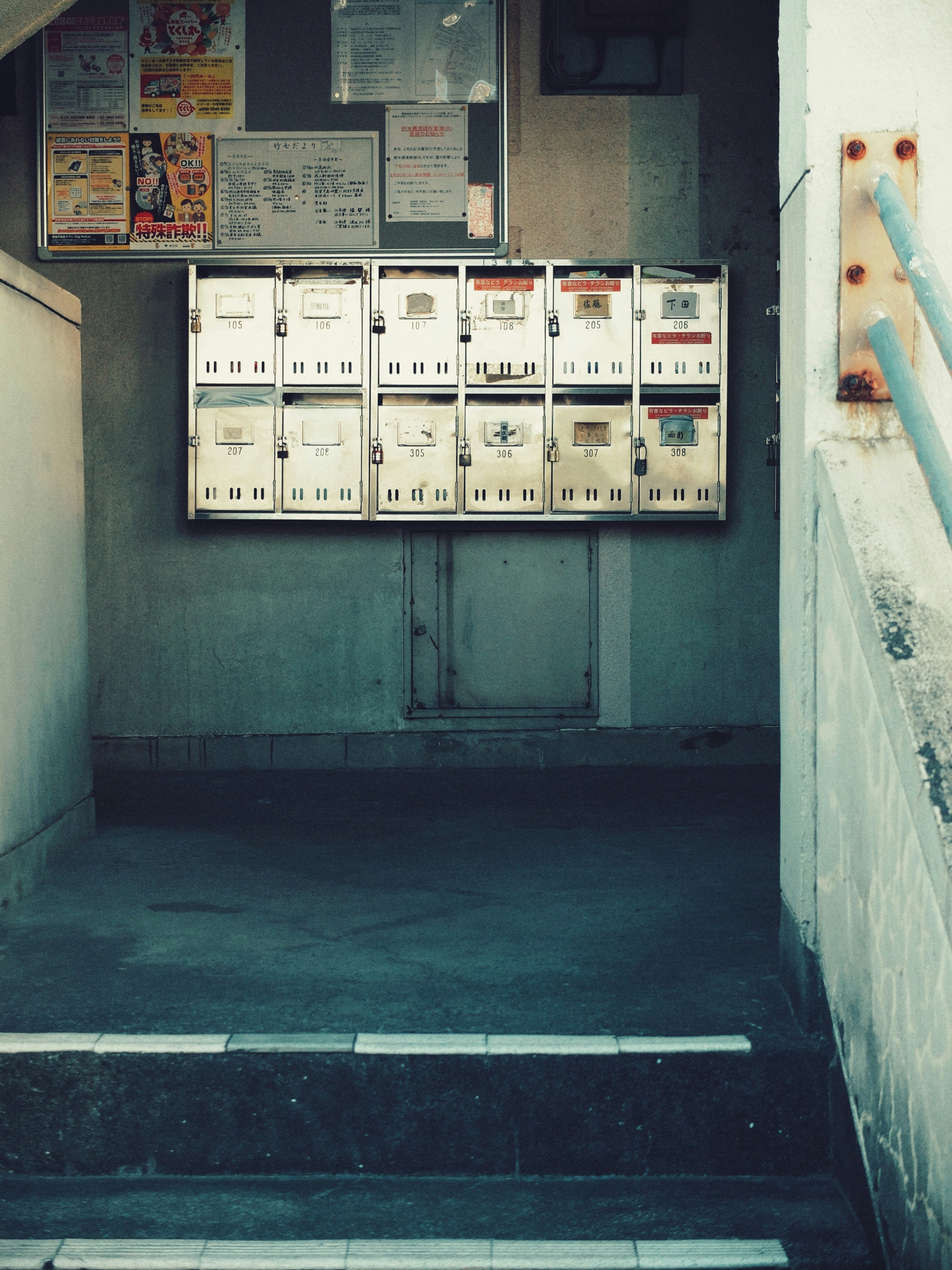 Retro apartment corridor with a bulletin board and mailboxes