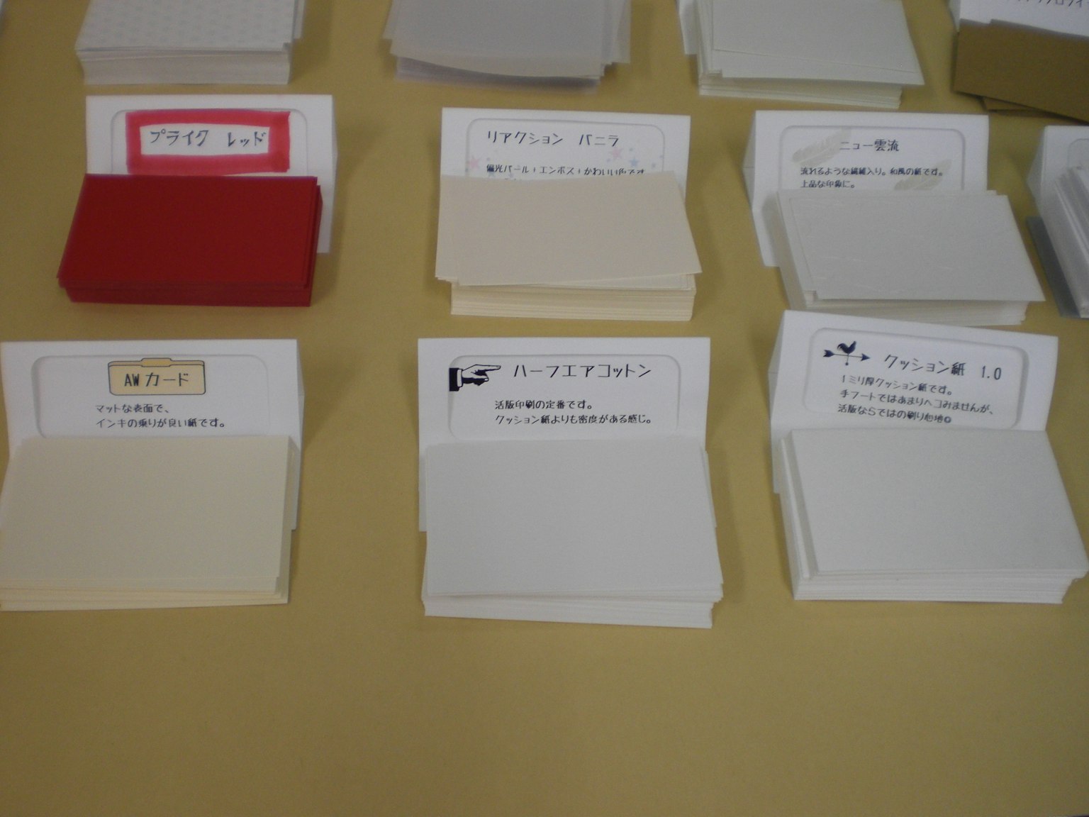 An assortment of small notepads in various colors arranged on a surface