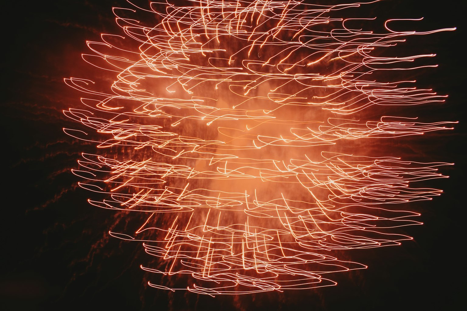 Abstract image featuring swirling red light patterns